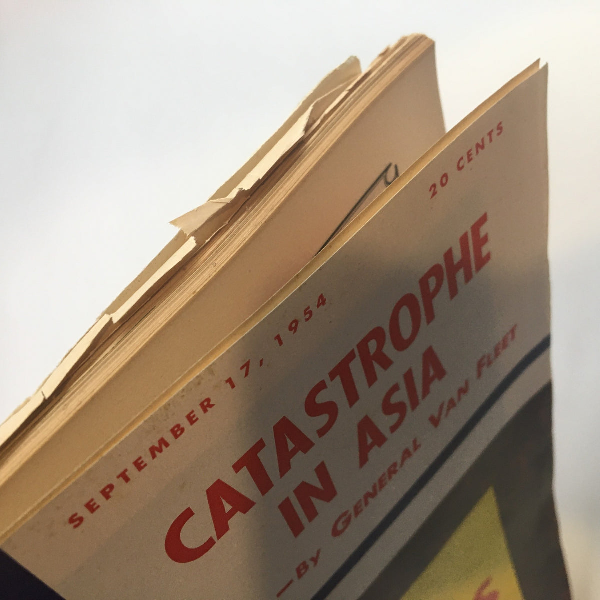 Side view of the US News & World Report Magazine September 17 1954 showing the worn edges and page quality, featuring the words 'Catastrophe in Asia'.