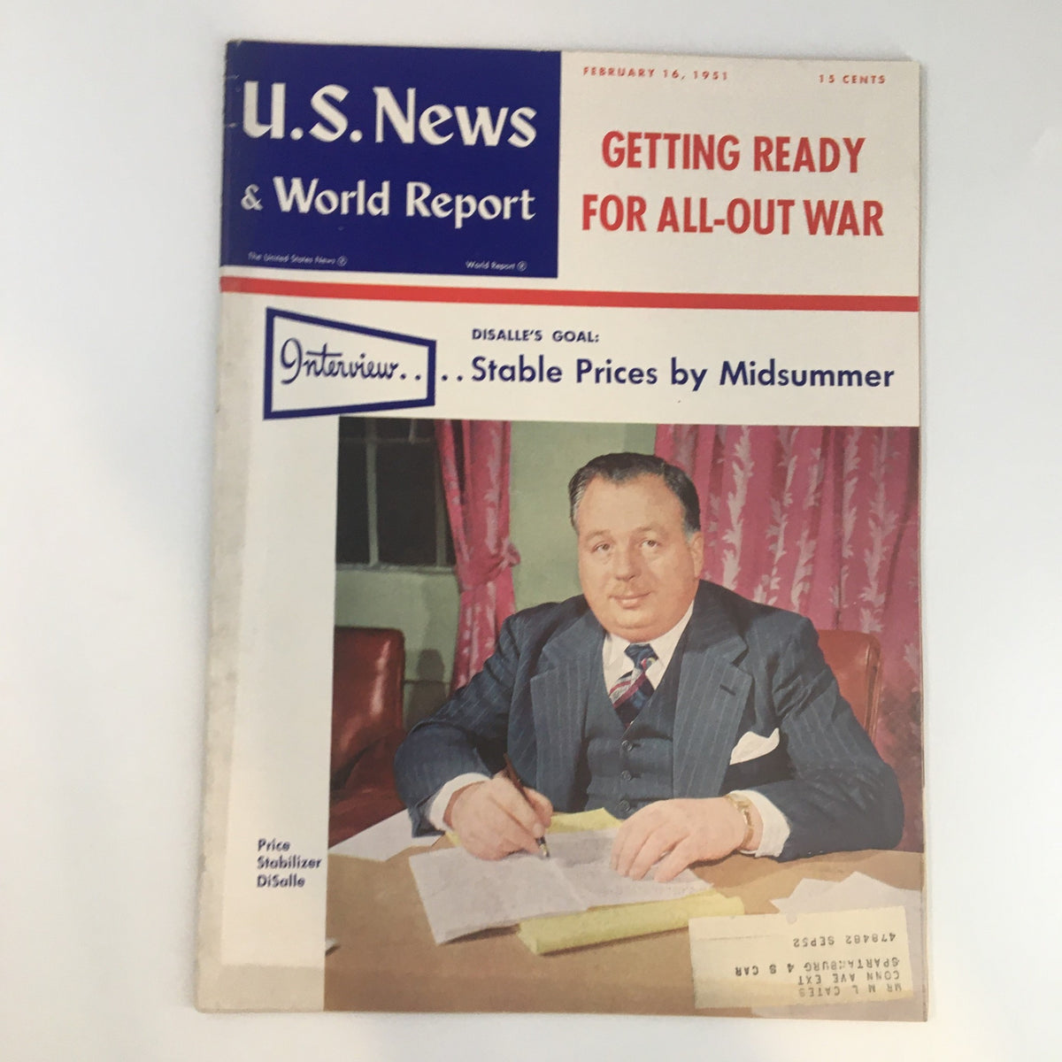 Cover of U.S. News & World Report Magazine from February 16, 1951, titled 'Getting Ready For All-Out War,' featuring an image of a man, likely a price stabilizer, seated and writing on documents.