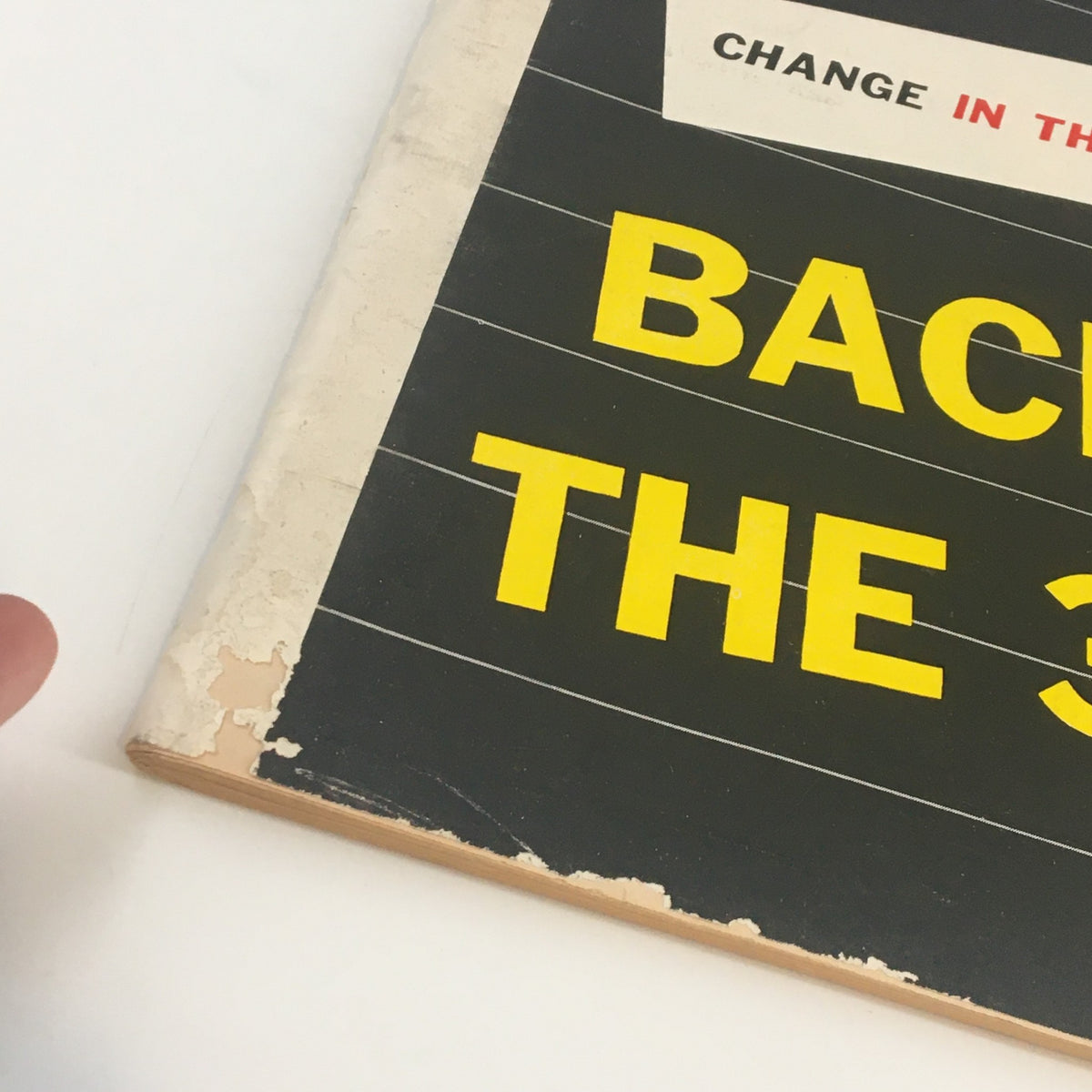 Close-up of the cover page of U.S. News & World Report Magazine from March 13, 1957, featuring a vintage design with partially visible yellow text and edges showing wear.