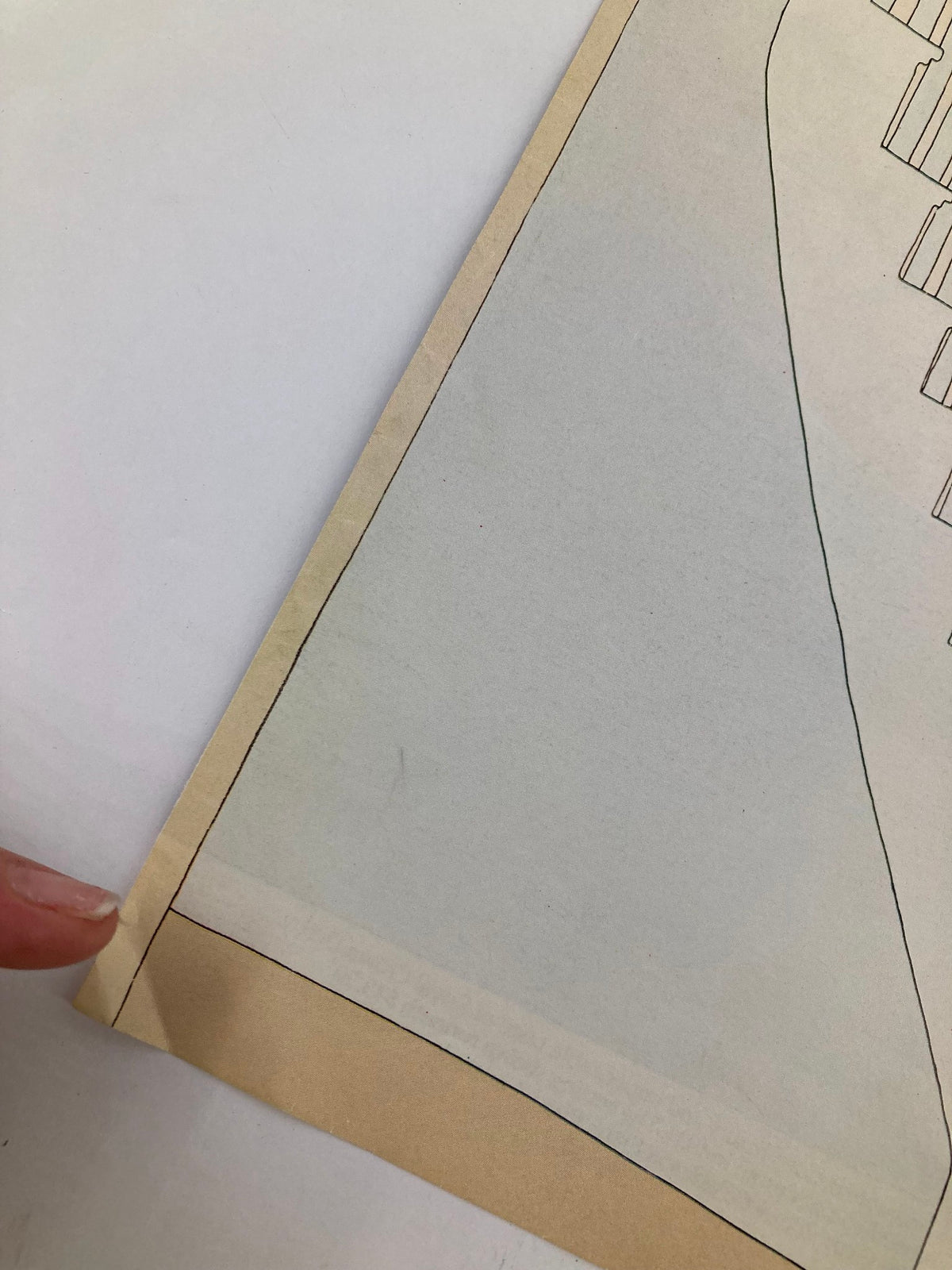 Close-up view of the corner of the 'COVER ONLY The New Yorker March 21 1977 Stairs by Gretchen Dow Simpson' magazine, showcasing its edges and minor wear. This collectible magazine features a unique illustration on its cover and comes with a protective plastic covering.