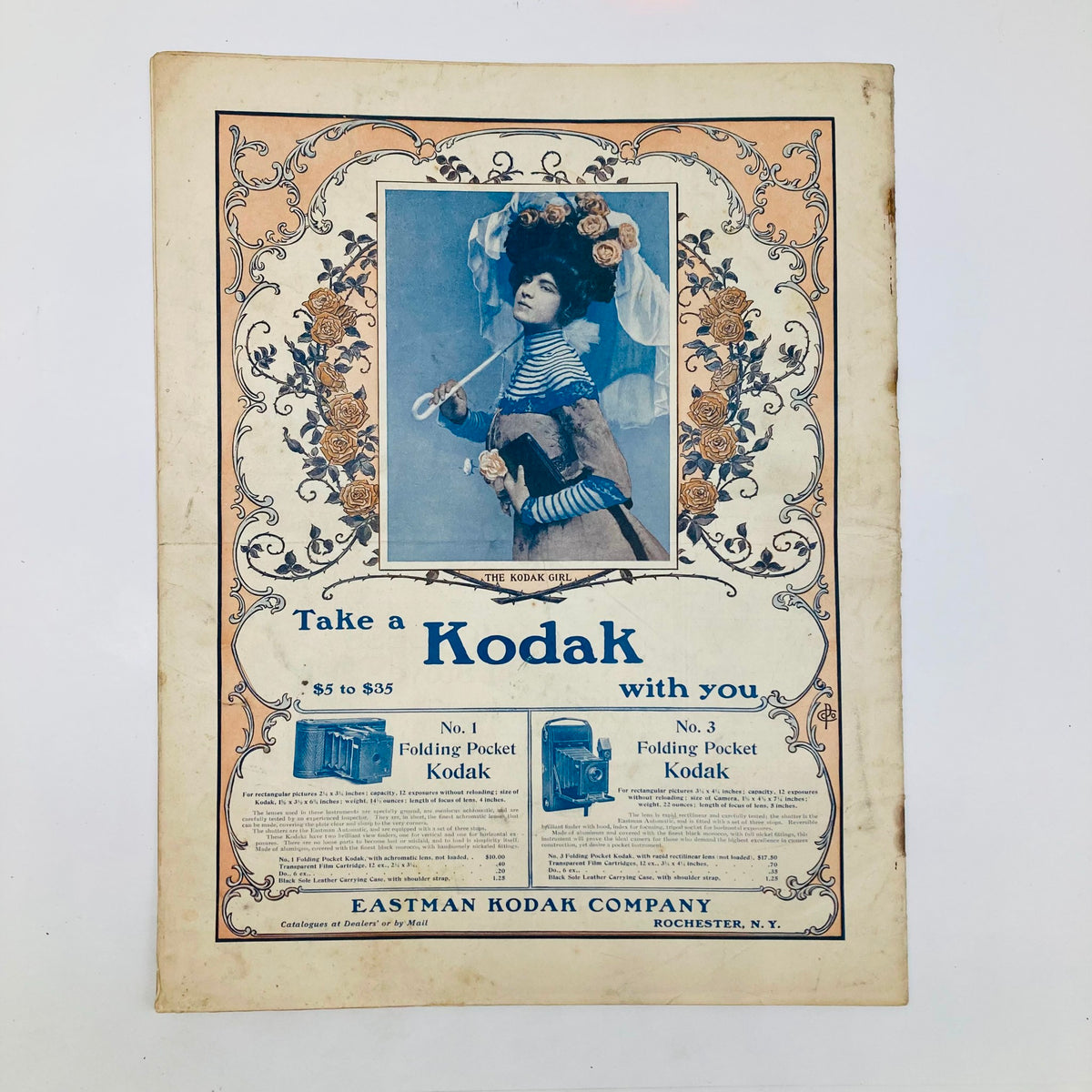 Saturday Evening Post Illustrated Cover May 25 1901 showcasing a vintage advertisement for Kodak cameras, featuring a young woman adorned with flowers in a historical design by Eastman Kodak Company.