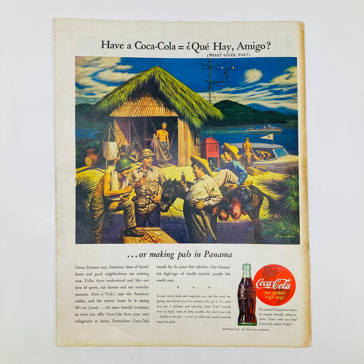 Advertising page from Saturday Evening Post Magazine featuring a Coca-Cola advertisement titled 'Have a Coca-Cola = ¿Qué Hay, Amigo?' showcasing American soldiers and locals enjoying Coca-Cola in Panama.