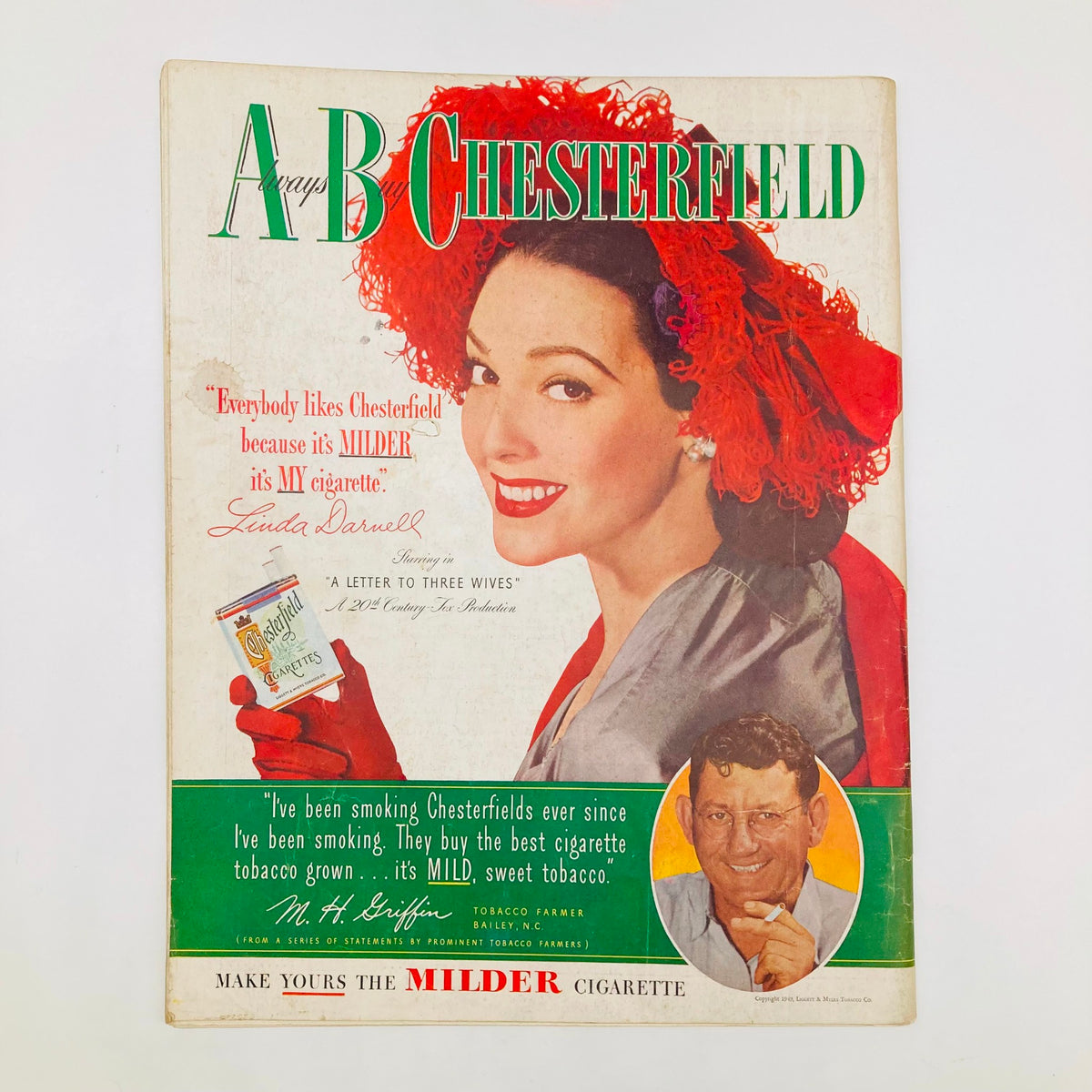 Cover of Chesterfield Cigarettes advertisement featuring a smiling woman with red gloves, highlighting the brand's appeal, from the Saturday Evening Post Magazine March 12 1949.