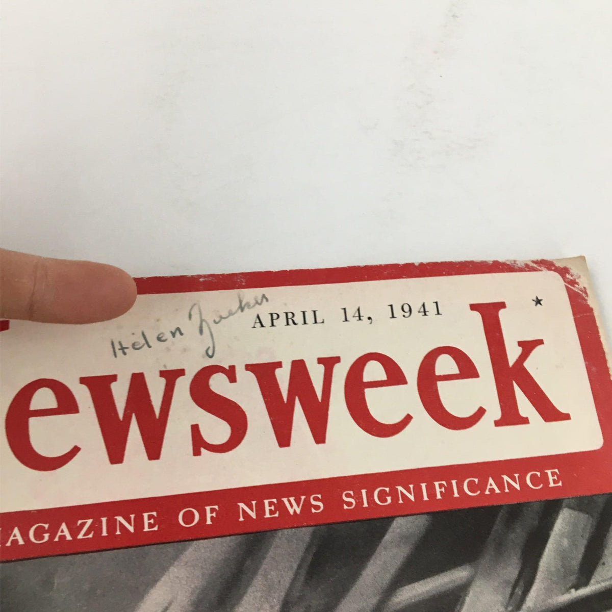 Detailed view of the top section of Newsweek Magazine from April 14, 1941 with the title 'Destruction on the March: Nazis Move Again'. The image focuses on the magazine's date and handwritten name along the top.