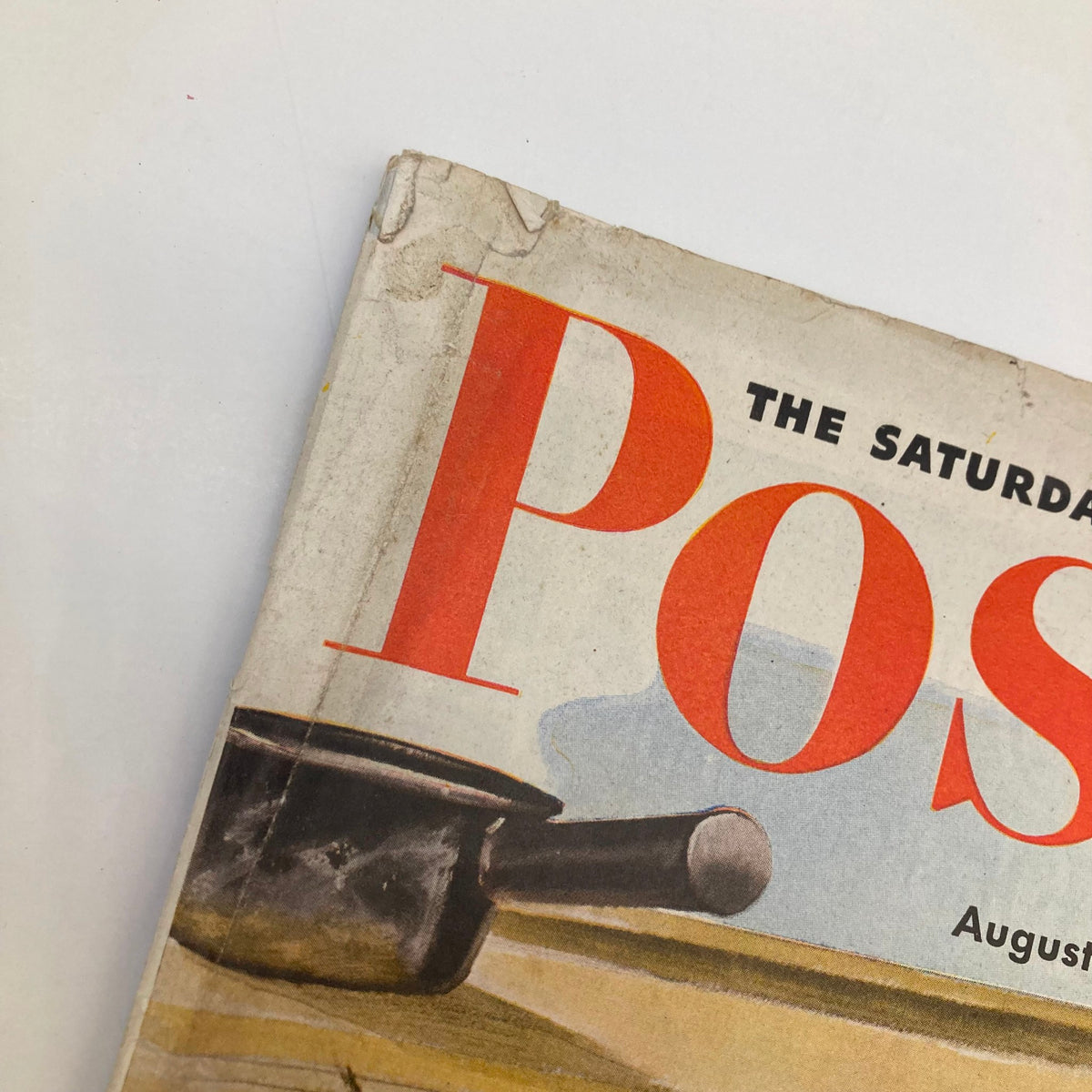 Side view of the Saturday Evening Post Magazine cover from August 15, 1942, highlighting the magazine title and artistic elements of the design, including a pan in the foreground.