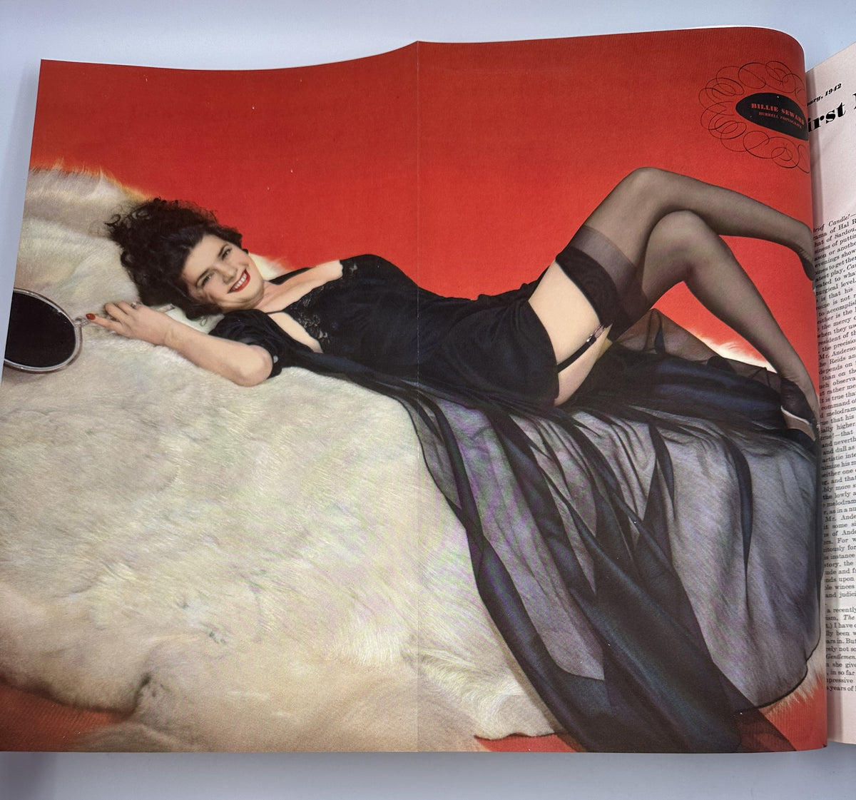 Color photograph of a model posed elegantly on a fur rug in Esquire Magazine February 1942, highlighting vintage fashion and iconic beauty standards of the era.