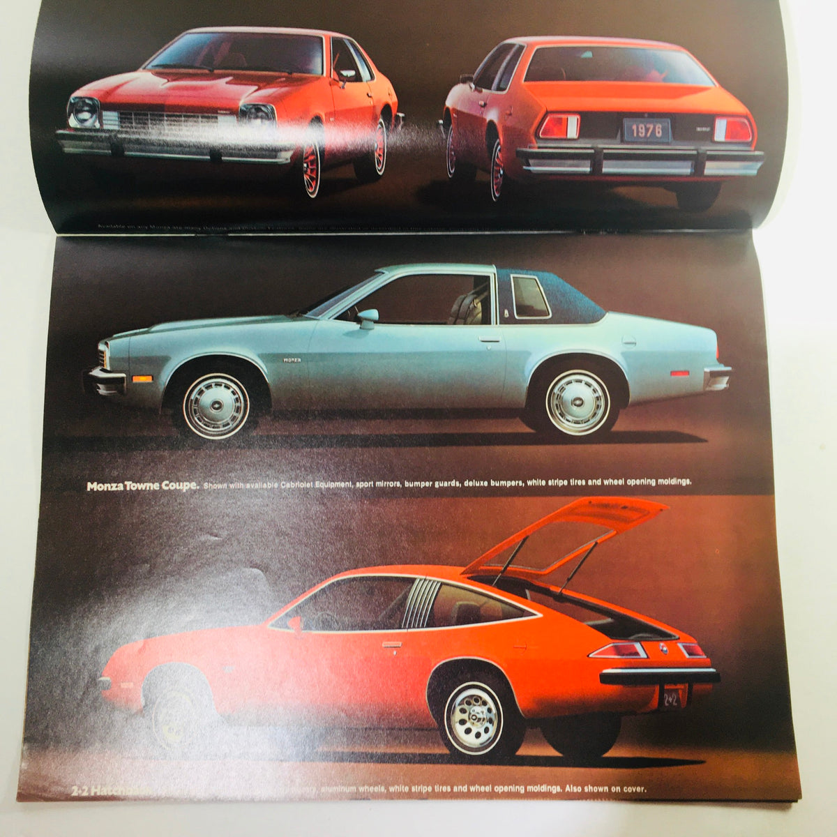 Interior spread of the Vintage 1976 Monza 2+2 Hatchback / Towne Coupe Chevrolet 2-Door Sedan Brochure showcasing various model angles in different colors.