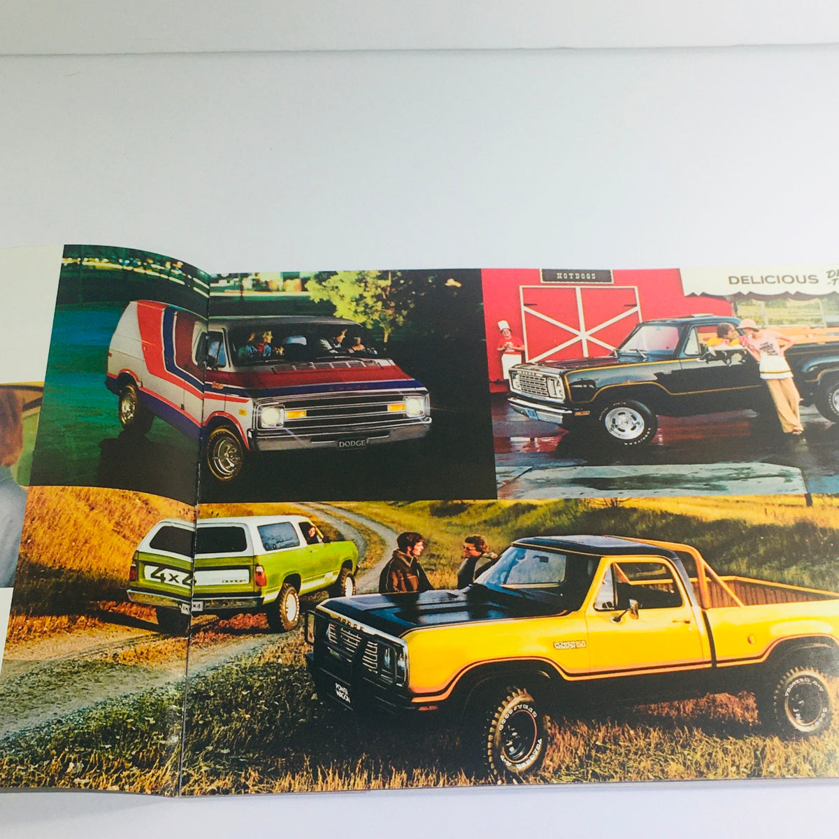 Interior pages of the 1978 Dodge brochure displaying various Dodge vehicles, including a colorful van and trucks, under the title 'A New Set of Adult Toys from Dodge'.