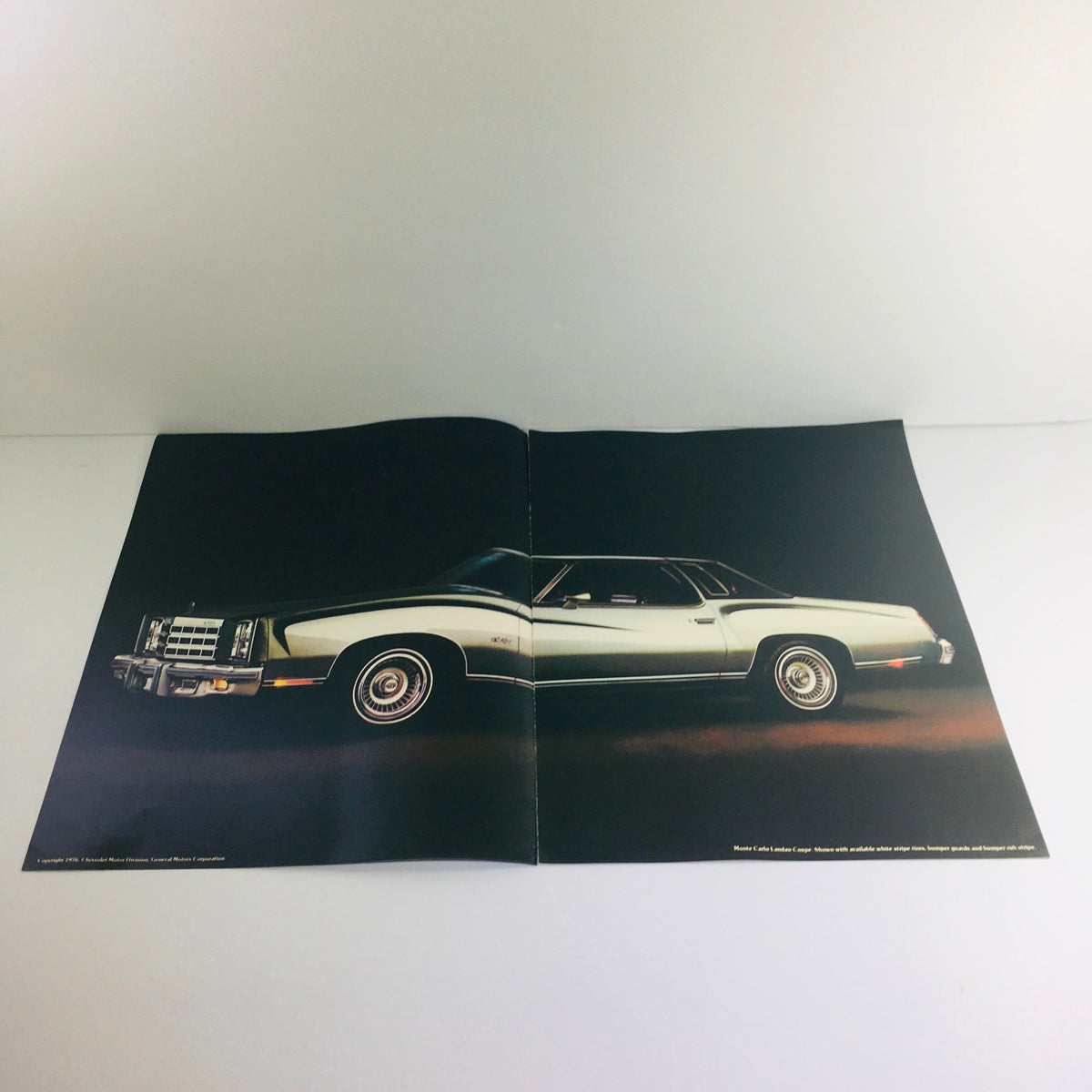 Side view of the vintage 1977 Monte Carlo Chevrolet car depicted in an open brochure.