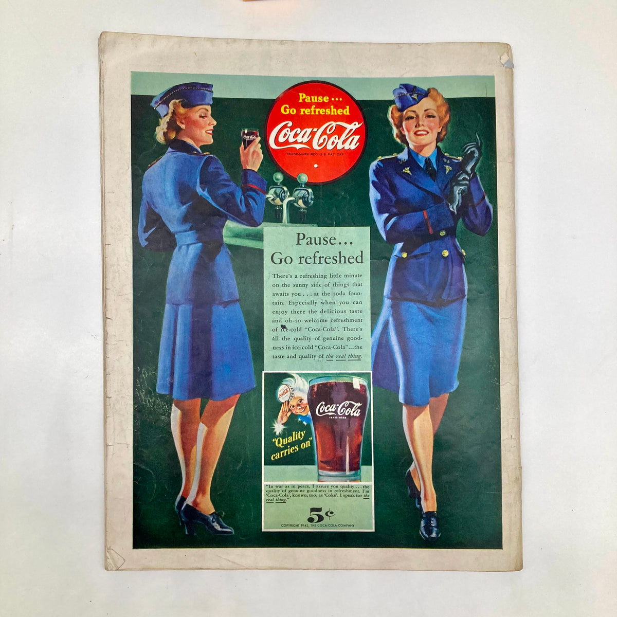 Vintage Coca-Cola advertisement featuring two women in military uniforms promoting refreshment. From the Saturday Evening Post Magazine September 19, 1942, Illustrated Cover by Howard Scott.