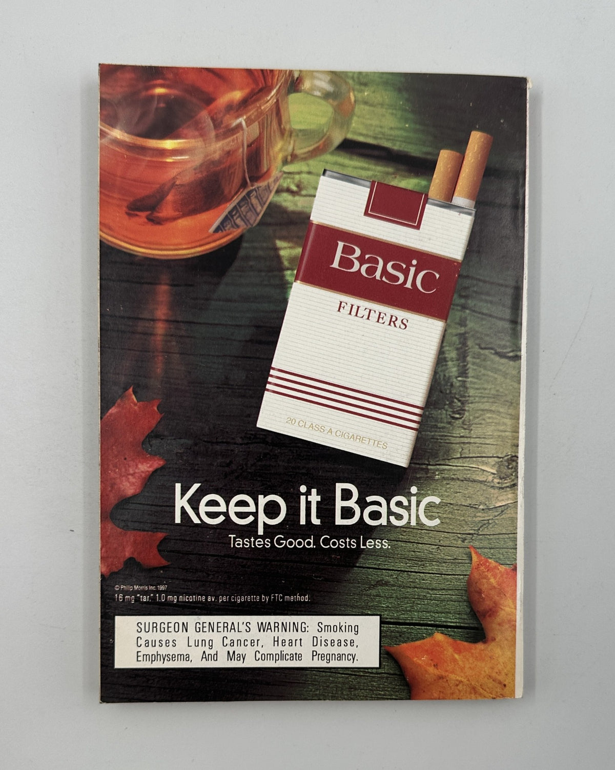 Advertisement for Basic Filters cigarettes featured in TV Guide Magazine, highlighting the brand's motto 'Keep it Basic, Tastes Good. Costs Less.' from the November 8, 1997 issue.