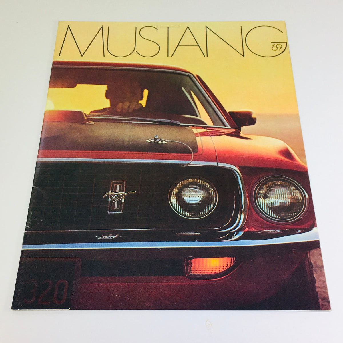 Vintage 1969 Ford Mustang Mach Hardtop Sedan brochure showcasing the iconic front view with headlights and grill, emphasizing the powerful 428 4-V Cobra engine, perfect for collectors and automobile enthusiasts.