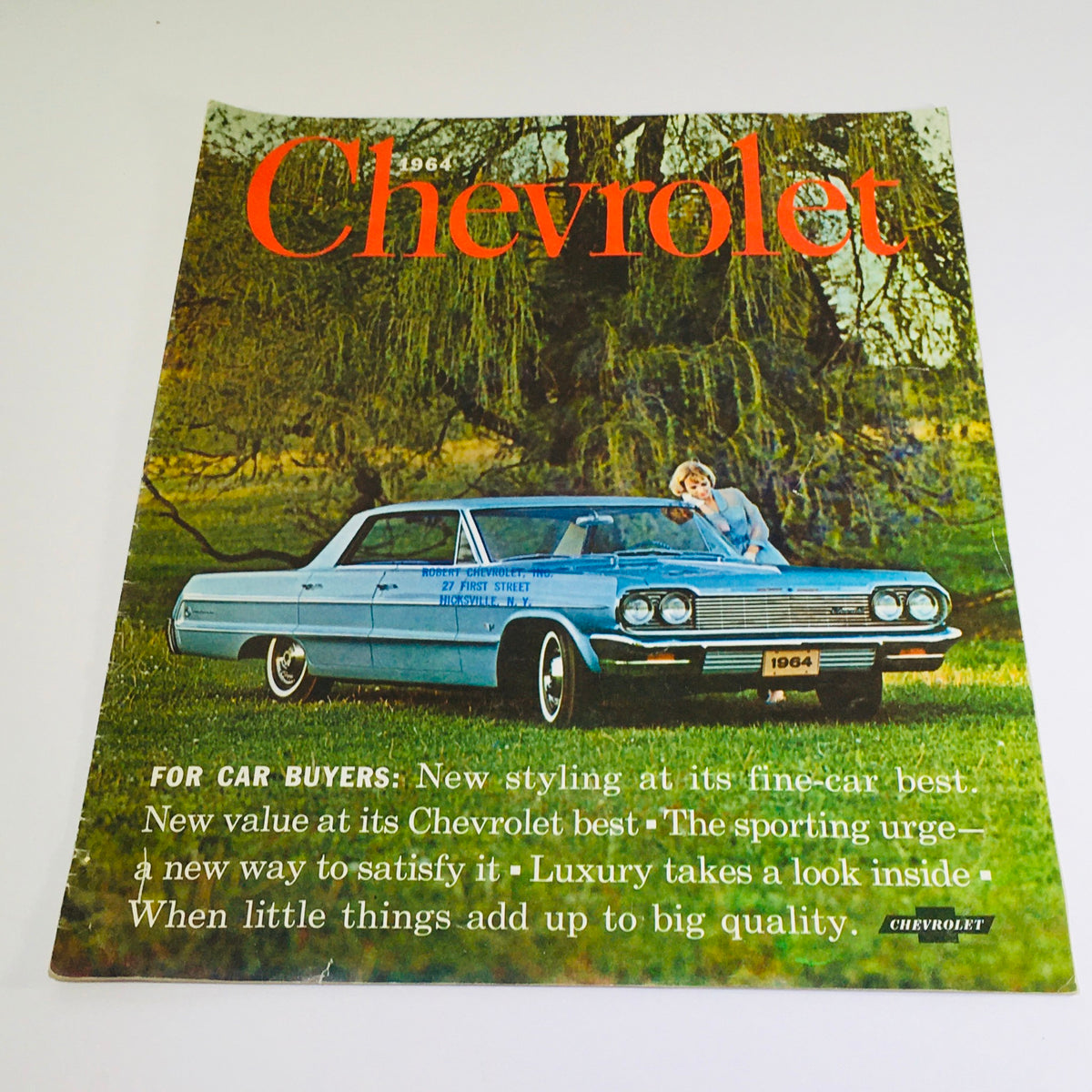 Vintage 1964 Chevrolet Impala sales brochure featuring a stylish blue sedan on the cover, showcasing the tagline 'FOR CAR BUYERS' emphasizing new styling and luxury.