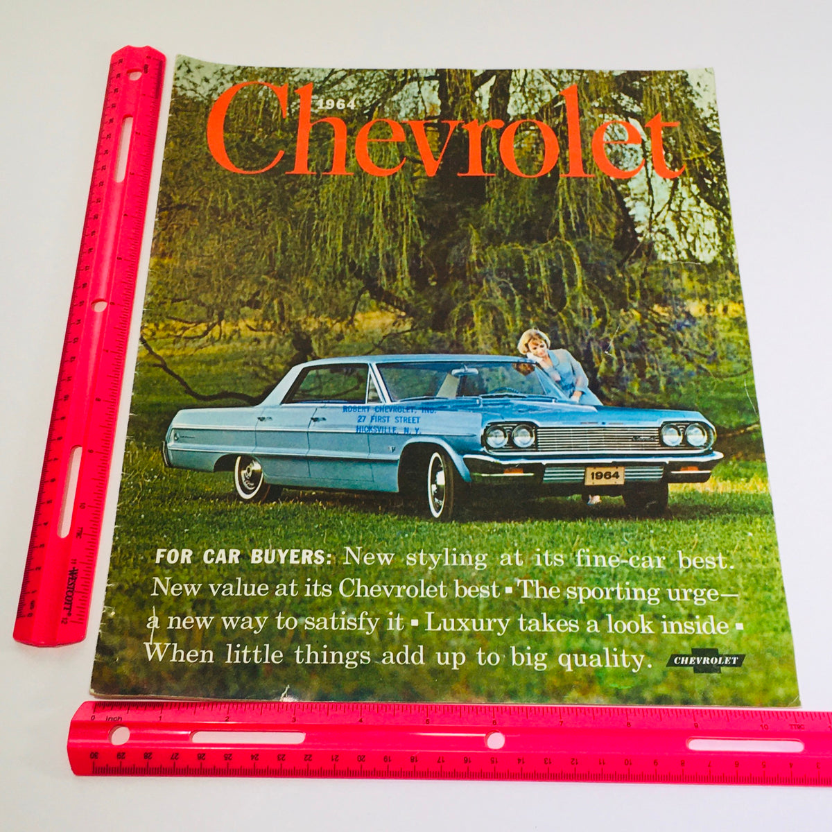 Cover view of the vintage 1964 Chevrolet Chevy Impala brochure, featuring the iconic car on a green lawn, designed for car buyers with detailed descriptions. Title: Vtg 1964 Chevrolet Chevy Impala 2 to 4-Door Auto Car sales catalog Brochure.