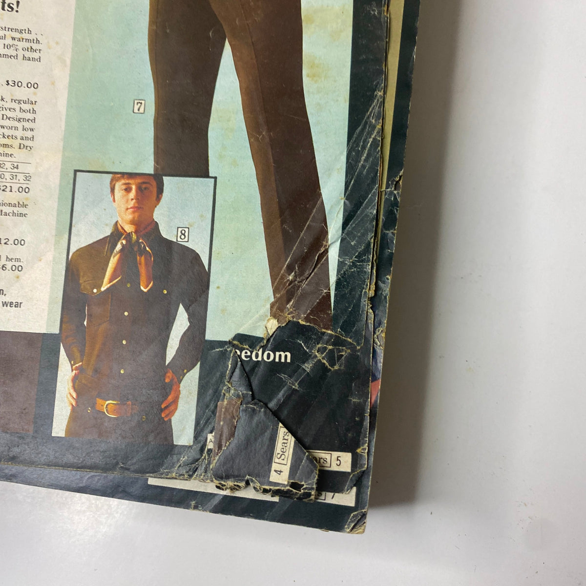 Close-up of a page from the 1969 Sears Fall and Winter Catalog displaying a male model in a fashionable outfit with a scarf.