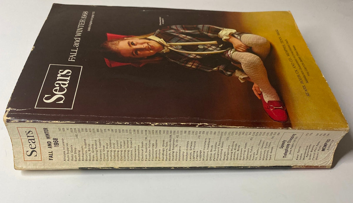 Side view of the 1968 Sears Fall and Winter Catalog displaying the spine and details, emphasizing its vintage design and historical significance.