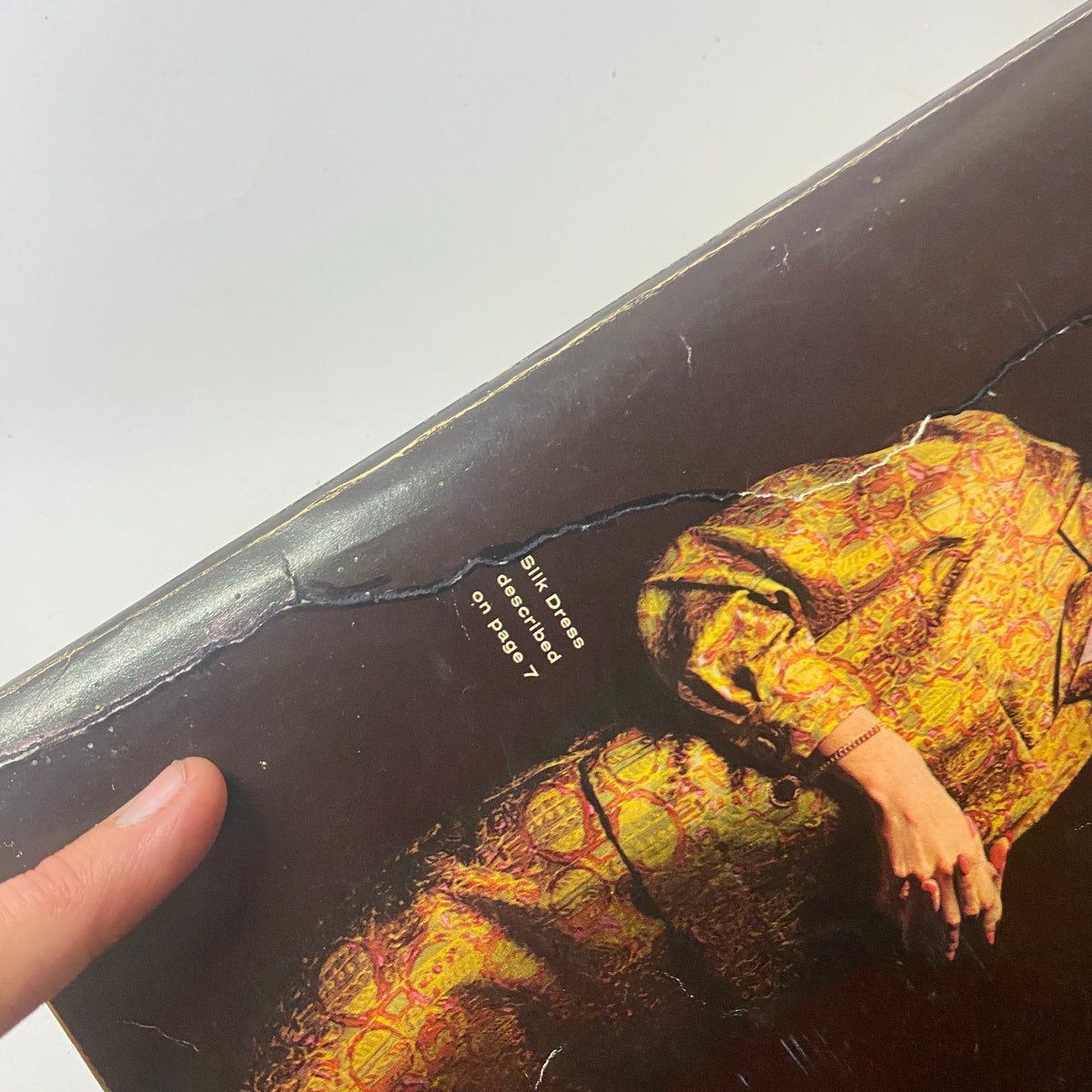 Close-up of the 1963 Sears Fall and Winter Catalog cover highlighting a silk dress description, emphasizing the vintage fashion details.