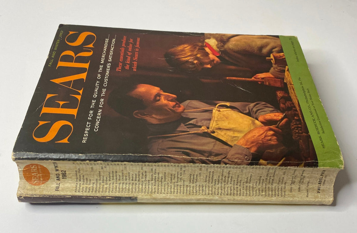 Side view of the 1962 Sears Fall and Winter Catalog emphasizing its vintage cover with a father and child, reflecting early 1960s consumer culture.