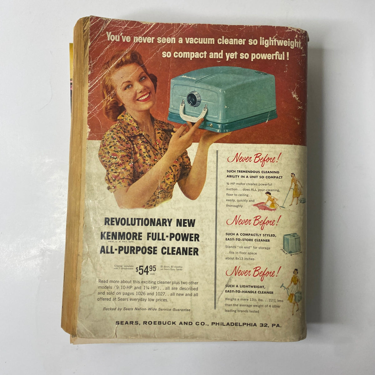 Cover of the 1957 Sears Roebuck and Co. Fall and Winter Catalog featuring Kenmore vacuum cleaner advertisement with a smiling woman demonstrating the product.