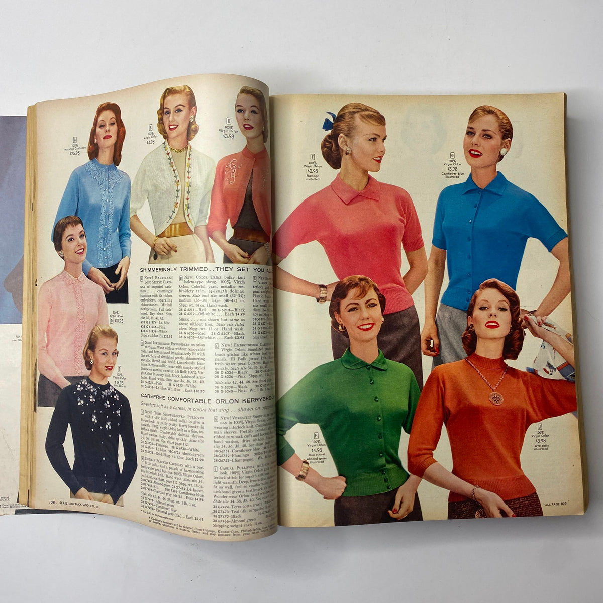 Page from the 1956 Sears Roebuck and Co. Fall and Winter Catalog showcasing vintage women's fashion including cardigans and blouses in various colors.