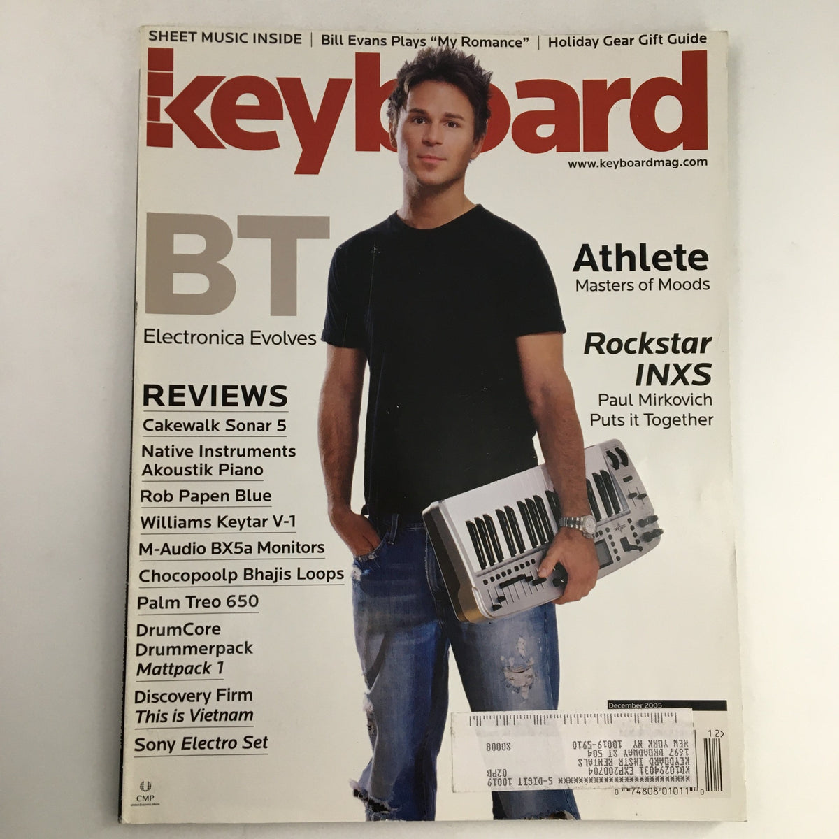 Cover image of Keyboard Magazine December 2005 featuring a musician holding a keyboard. The issue includes highlights on Bill Evans and insights from Rockstar INXS's Paul Mirkovich.