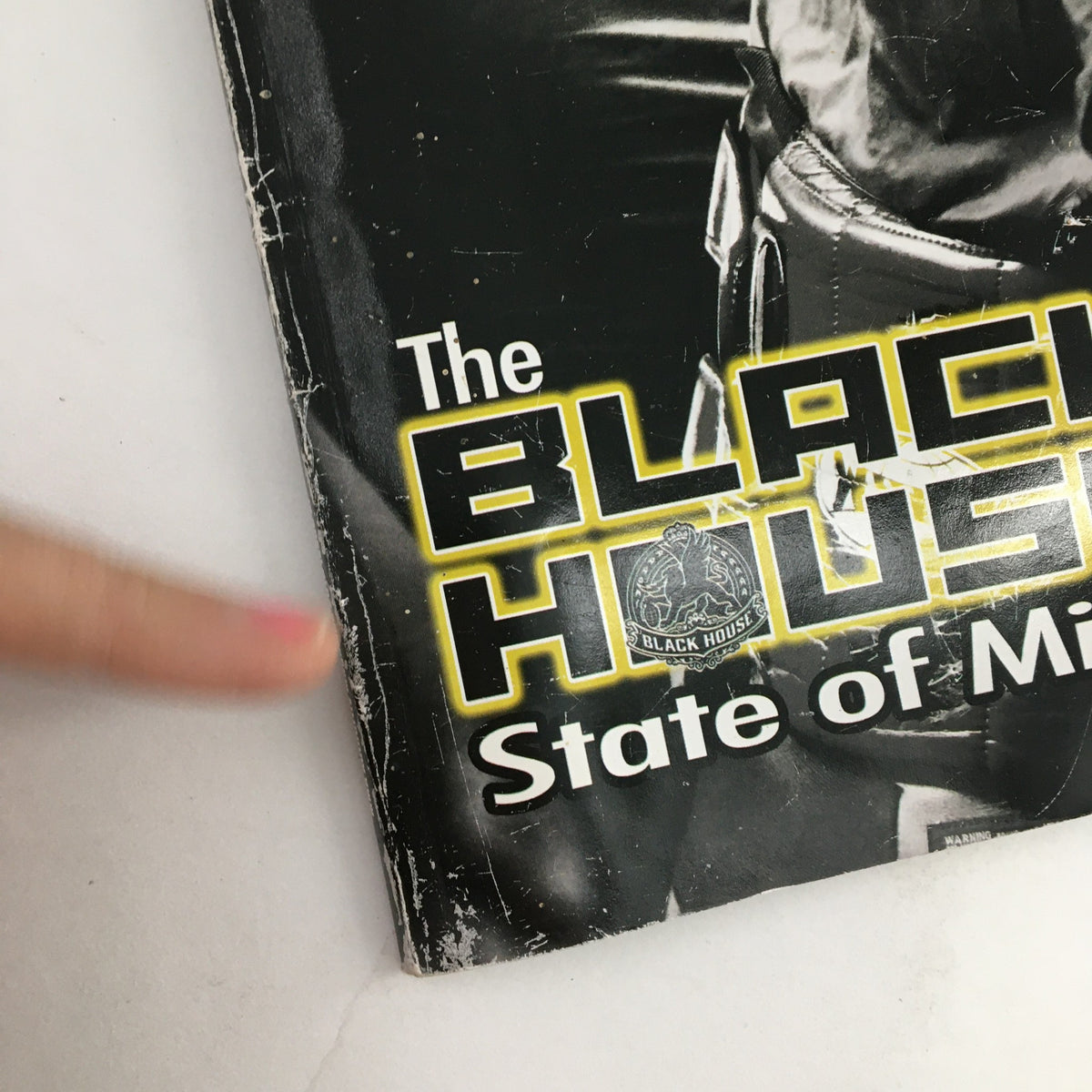 Detail of the cover of Authority MMA Magazine 2010 #11, emphasizing the caption 'The Black House State of Mind' as well as minor signs of vintage wear, illustrating its collectible status.