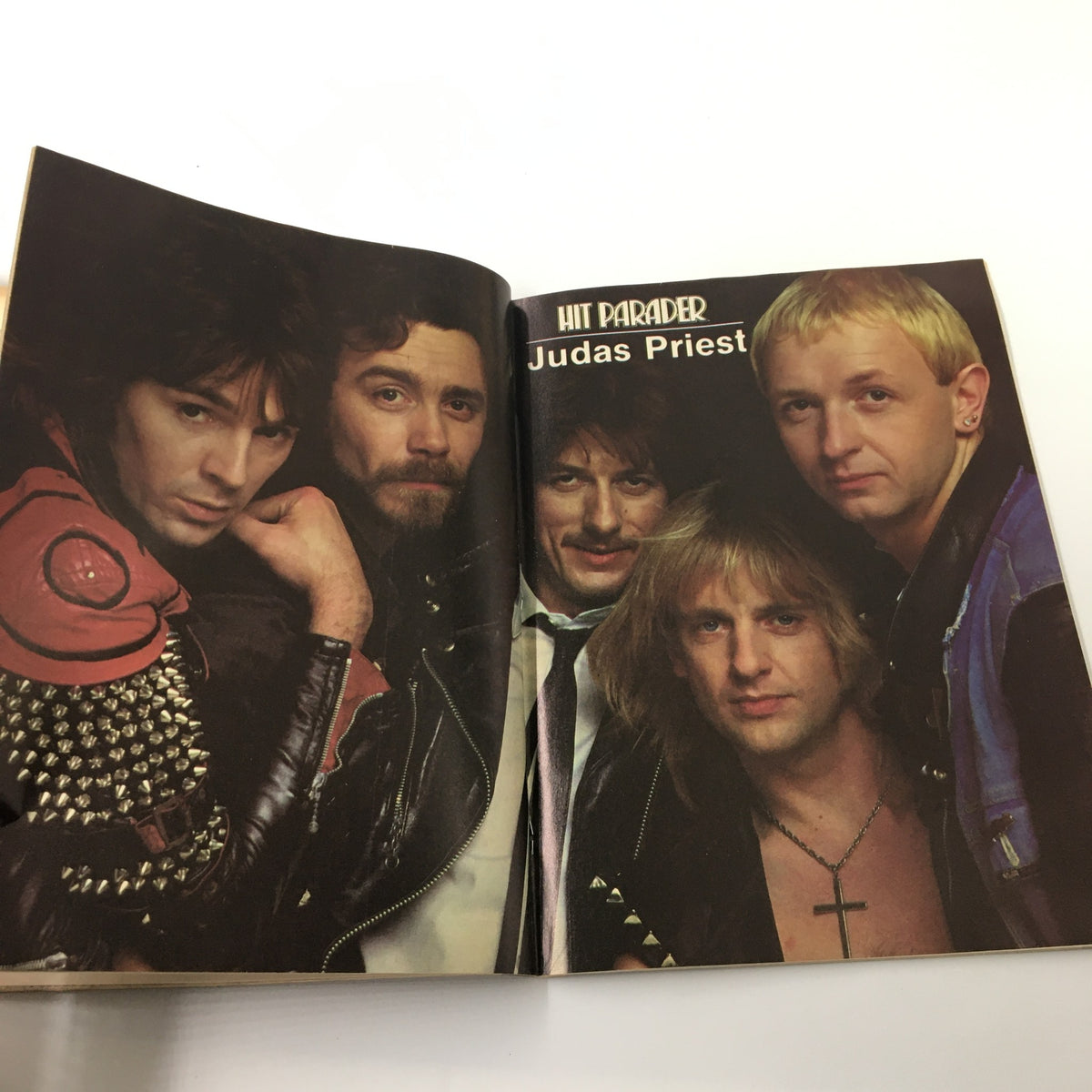 Inside spread of VTG Hit Parader Magazine February 1985 highlighting Judas Priest, showcasing the band's members and concert imagery.
