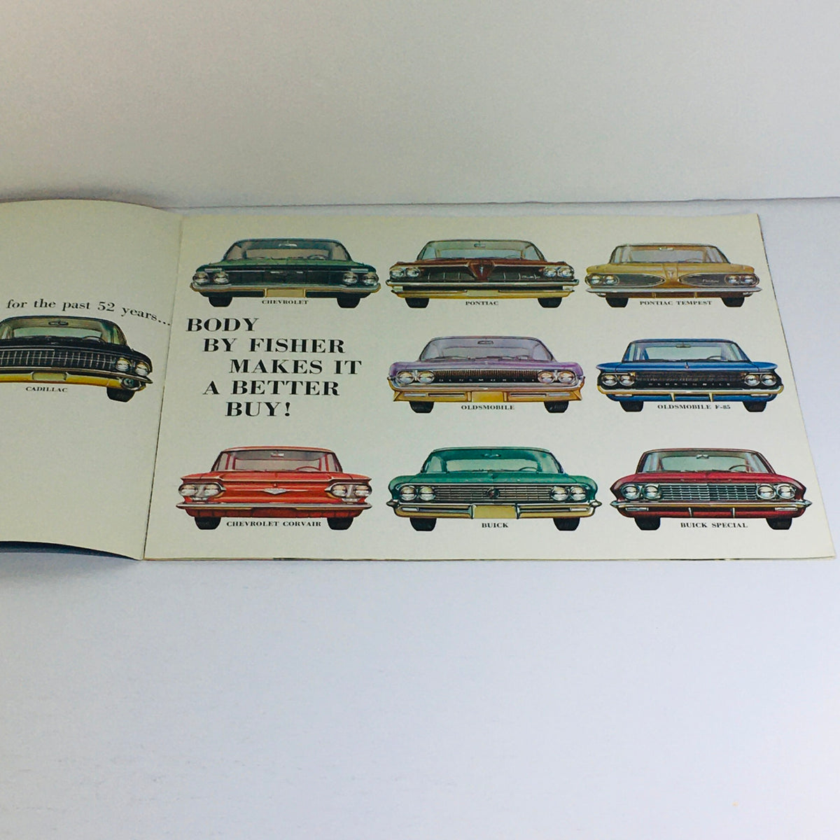 Inside page of the 1961 Fisher Body brochure showcasing colored illustrations of Chevrolet, Pontiac, Oldsmobile, and Buick models, emphasizing 'Body by Fisher makes it a better buy'.