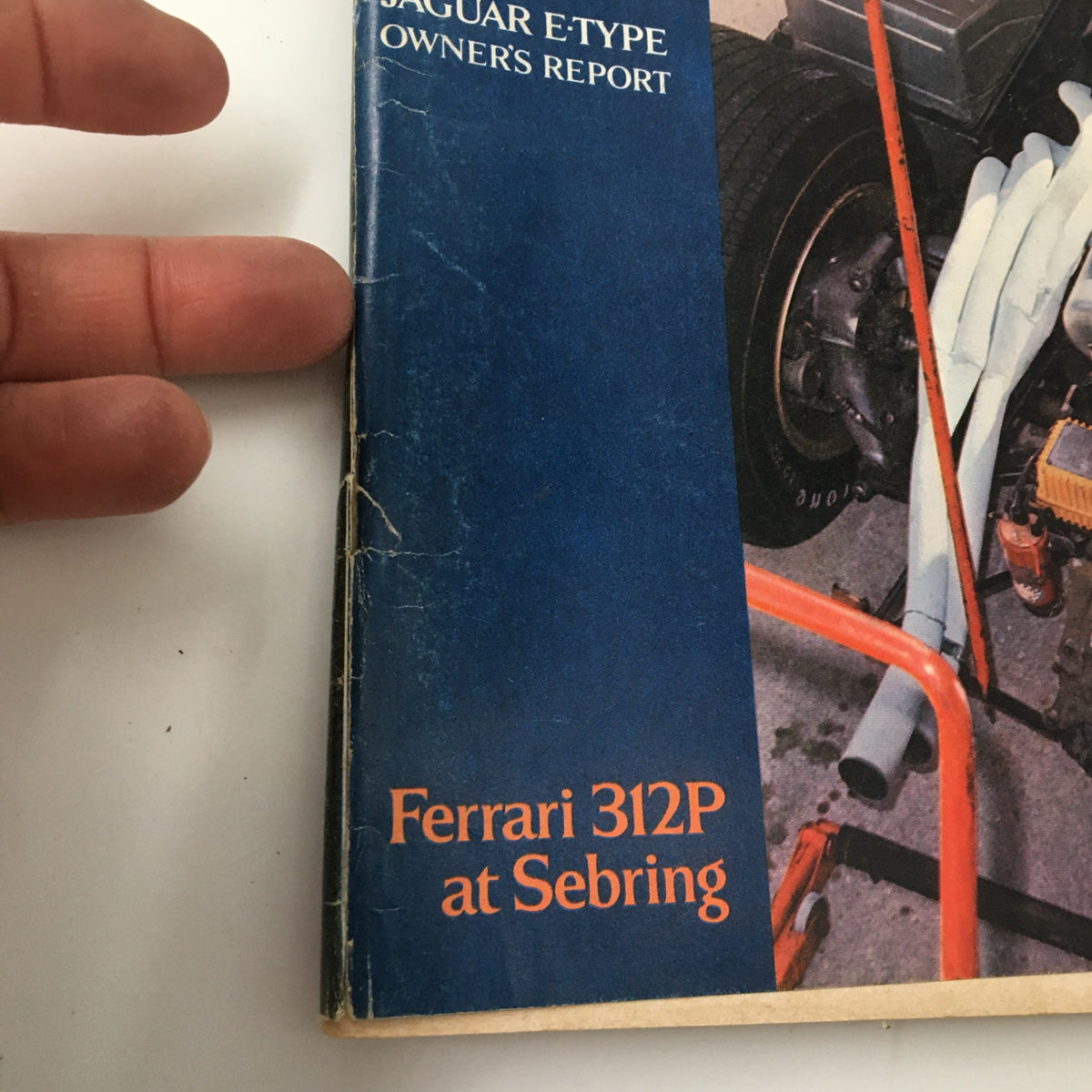 Close-up of the spine of the VTG Road & Track Magazine July 1969, showcasing the title Ferrari 312P at Sebring, featuring minor wear indicating its vintage status.
