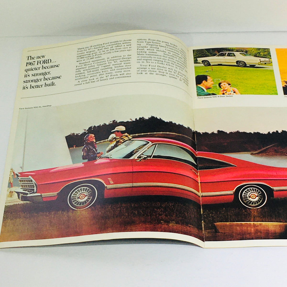 Inside view of the 1967 Ford Galaxie 500/XL Sedan Dealership Brochure showcasing a red Ford car with a couple enjoying the outdoors, highlighting Ford's strong and stylish vehicles.