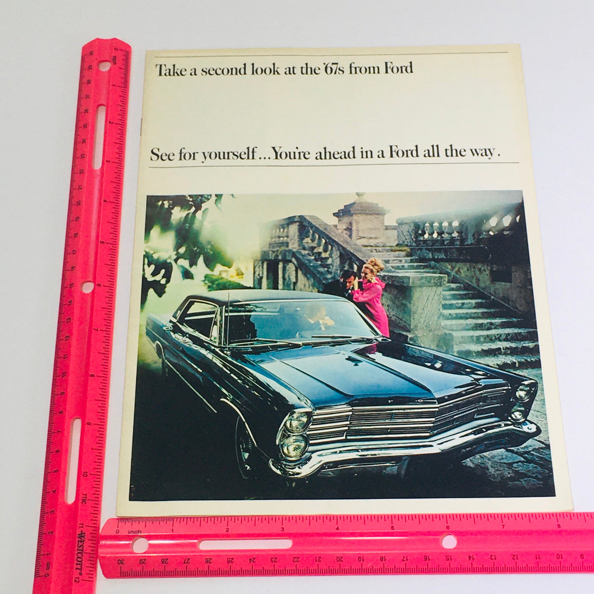 1967 Ford Galaxie 500/XL Sedan Dealership Car Auto Brochure Catalog displayed with a ruler for scale, featuring a picturesque Ford car image and promotional text.