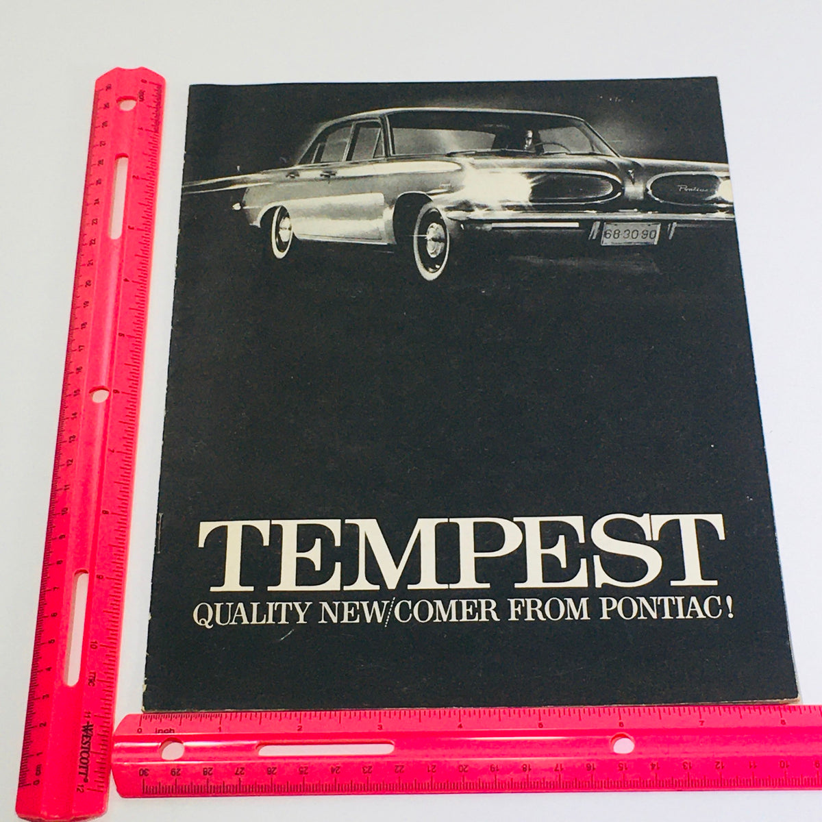 1961 Pontiac Tempest Showroom Dealership Car Auto Brochure Catalog displaying the Pontiac Tempest with a ruler for size reference, emphasizing its elegant styling.