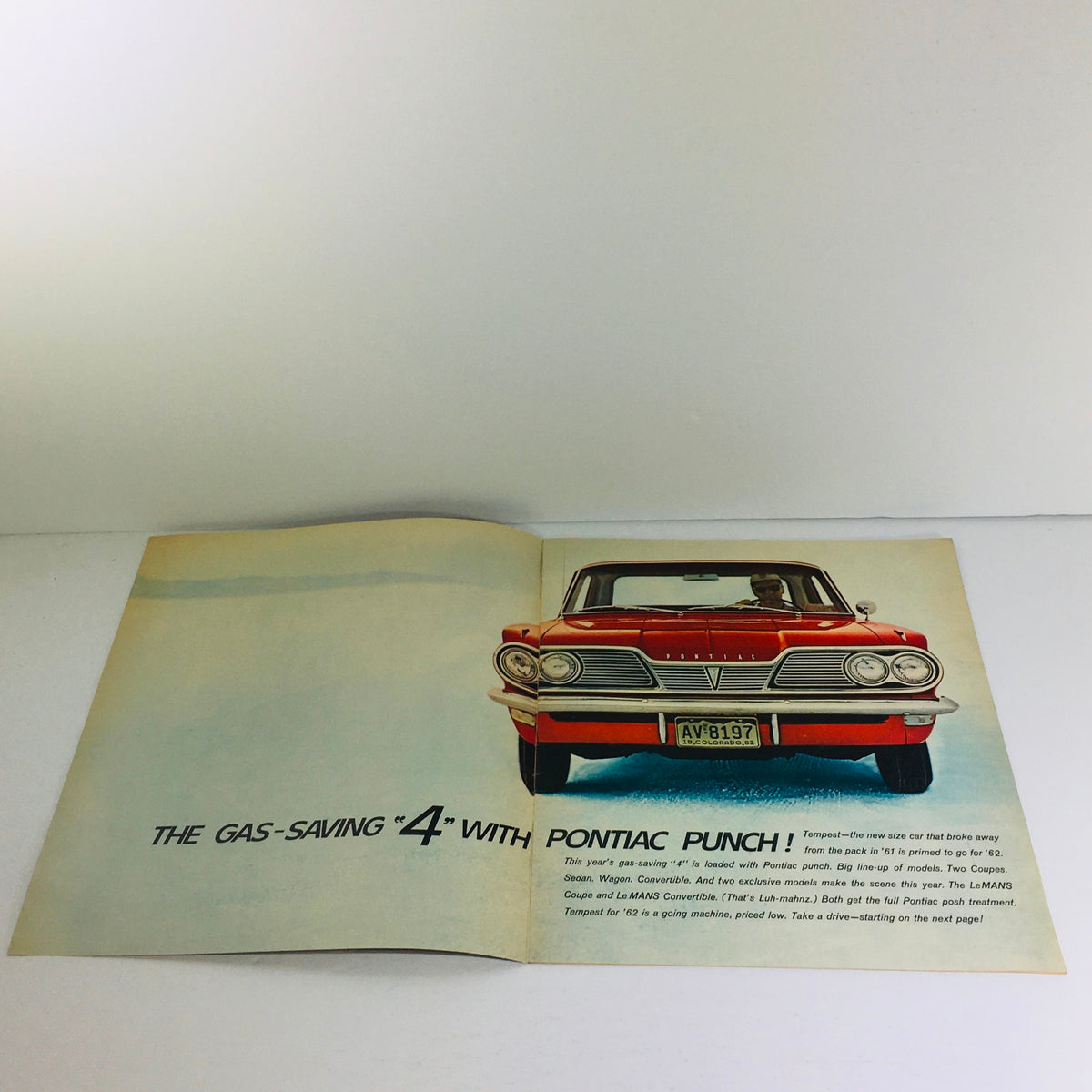 Interior page of the 1962 Pontiac Tempest Coupe-Sedan-Wagon Dealership Car auto brochure showcasing the car with 'Pontiac Punch' tagline.
