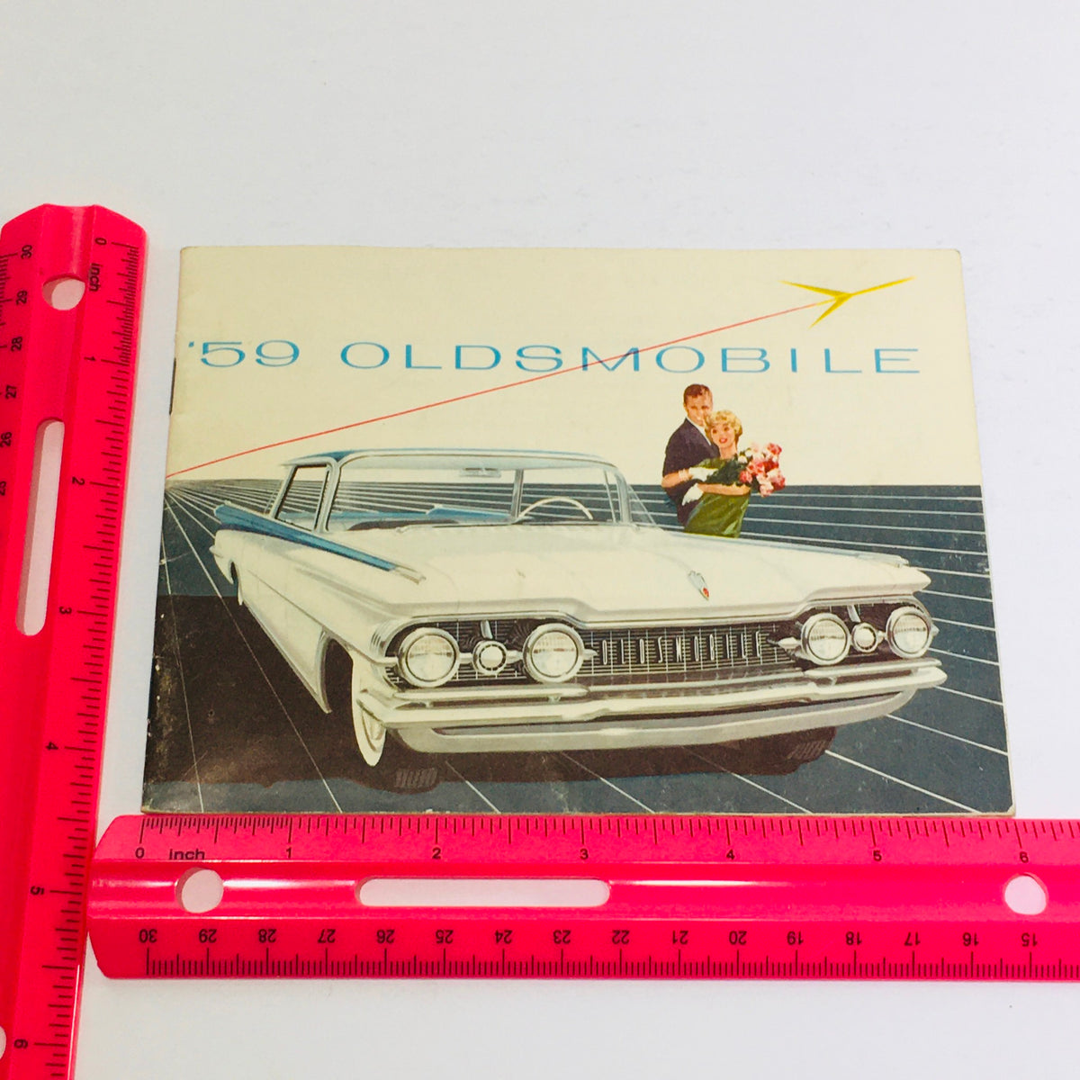 1959 Oldsmobile Holiday SceniCoupe Dealership Car Auto Brochure Catalog cover featuring a stylish car design and a couple, showcasing vintage automotive advertising.