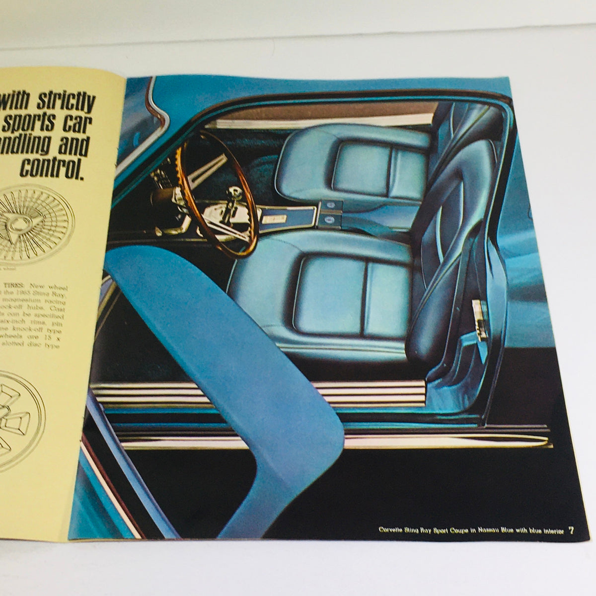 Interior page of the 1965 Chevrolet Corvette Stingray Coupe brochure featuring a detailed illustration of the blue interior with a sporty design and steering wheel.