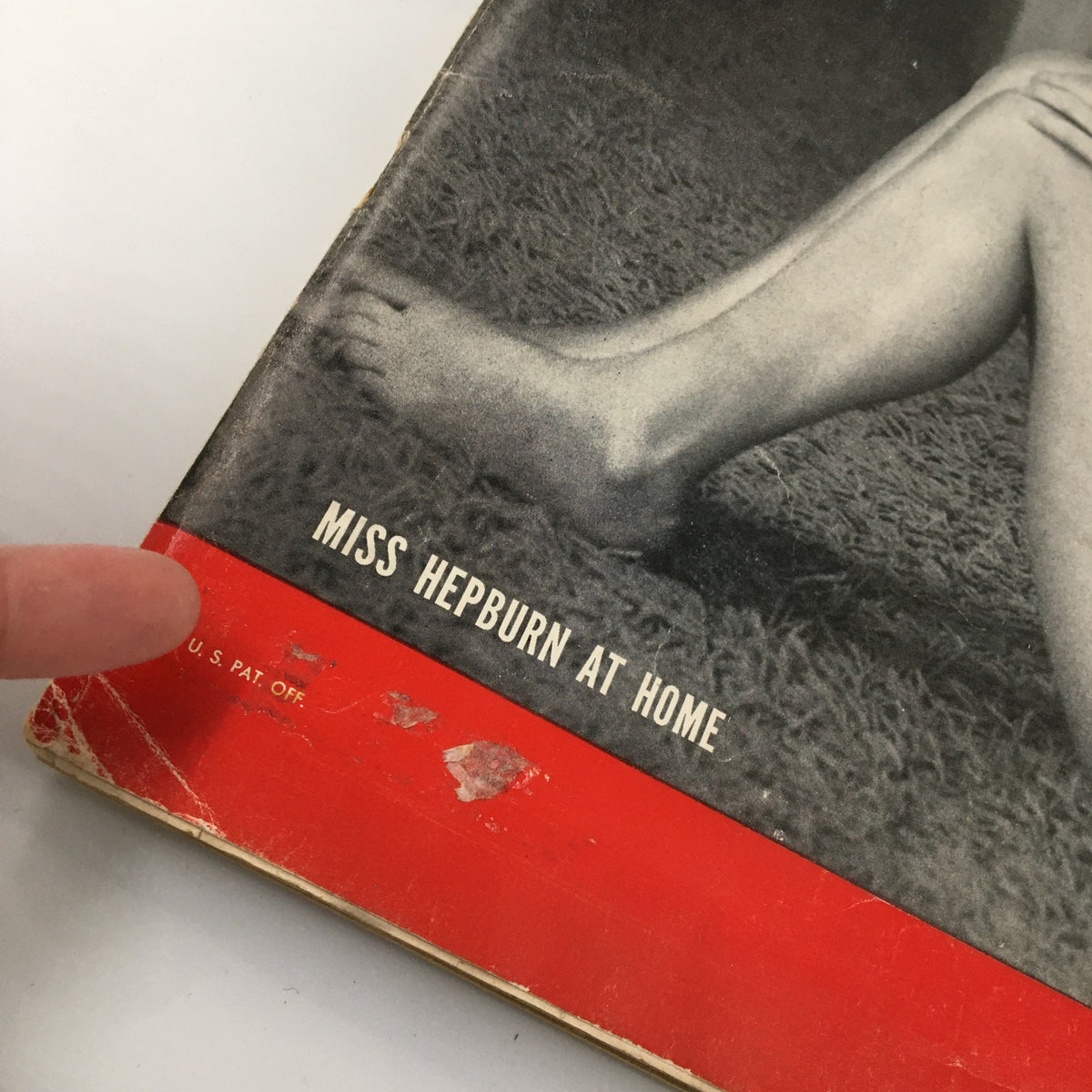 Close-up view of the cover of VTG Life Magazine December 7 1953, featuring the text 'Miss Hepburn at Home' and showing the edge of a classic magazine.