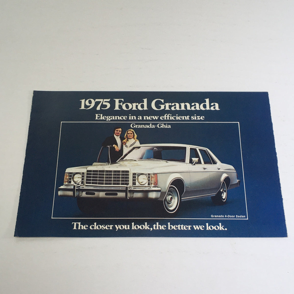 1975 Ford Granada Ghia Option Highlights showcasing a stylish 1975 Ford Granada sedan, featuring a bold front design with the tagline 'Elegance in a new efficient size'. This auto brochure highlights the vehicle's appeal and sophistication, perfect for car enthusiasts.