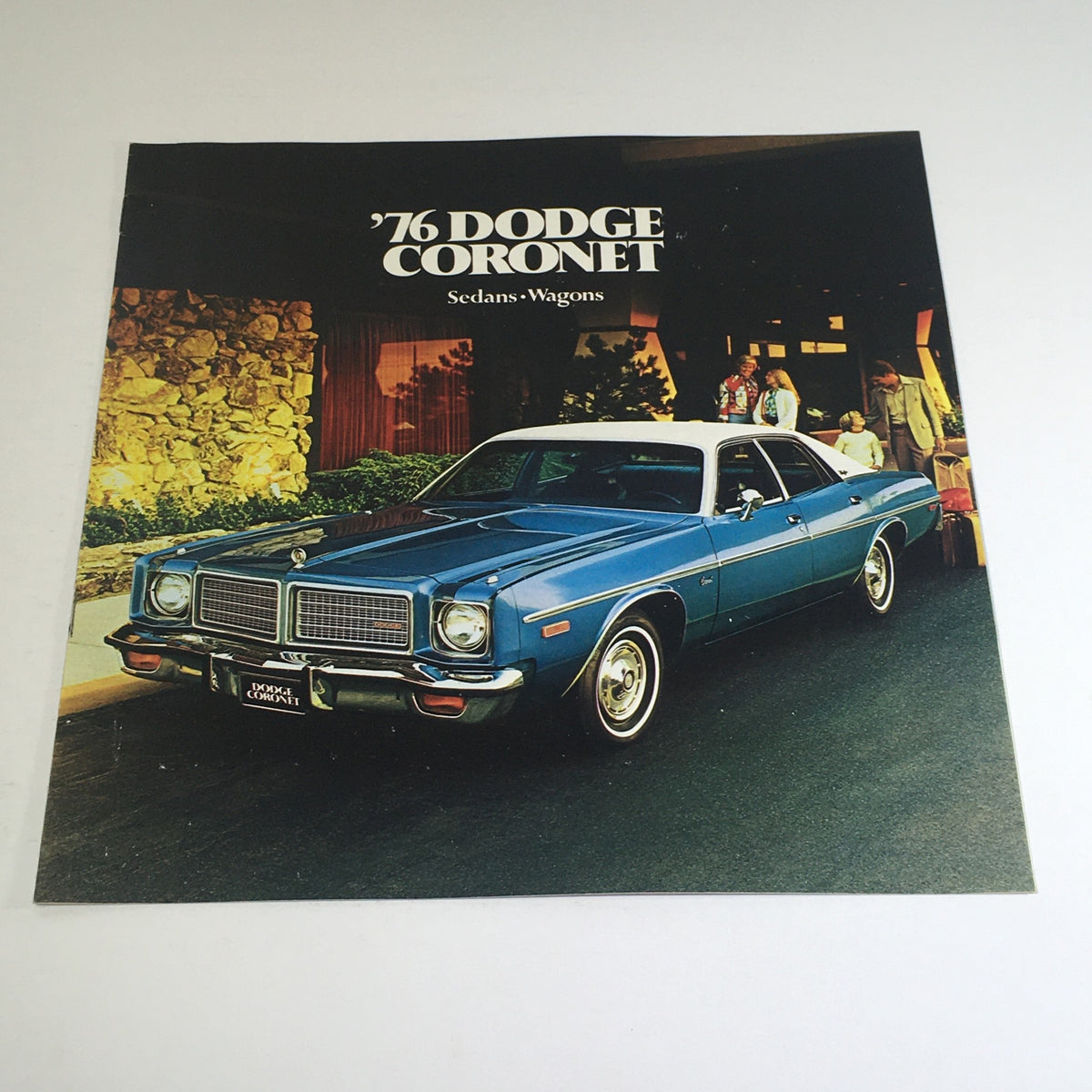 1976 Dodge Coronet Sedans, Wagons Specifications Car Auto Brochure Catalog cover featuring a blue Dodge Coronet parked with a picturesque background.