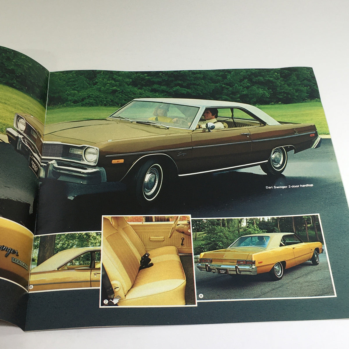 1976 Dodge Dart Hardtops, Sedans, Coupe Specifications Car Auto Brochure Catalog featuring a brown Dodge Dart Swinger driving on a road with interior details shown including seating and rear view.