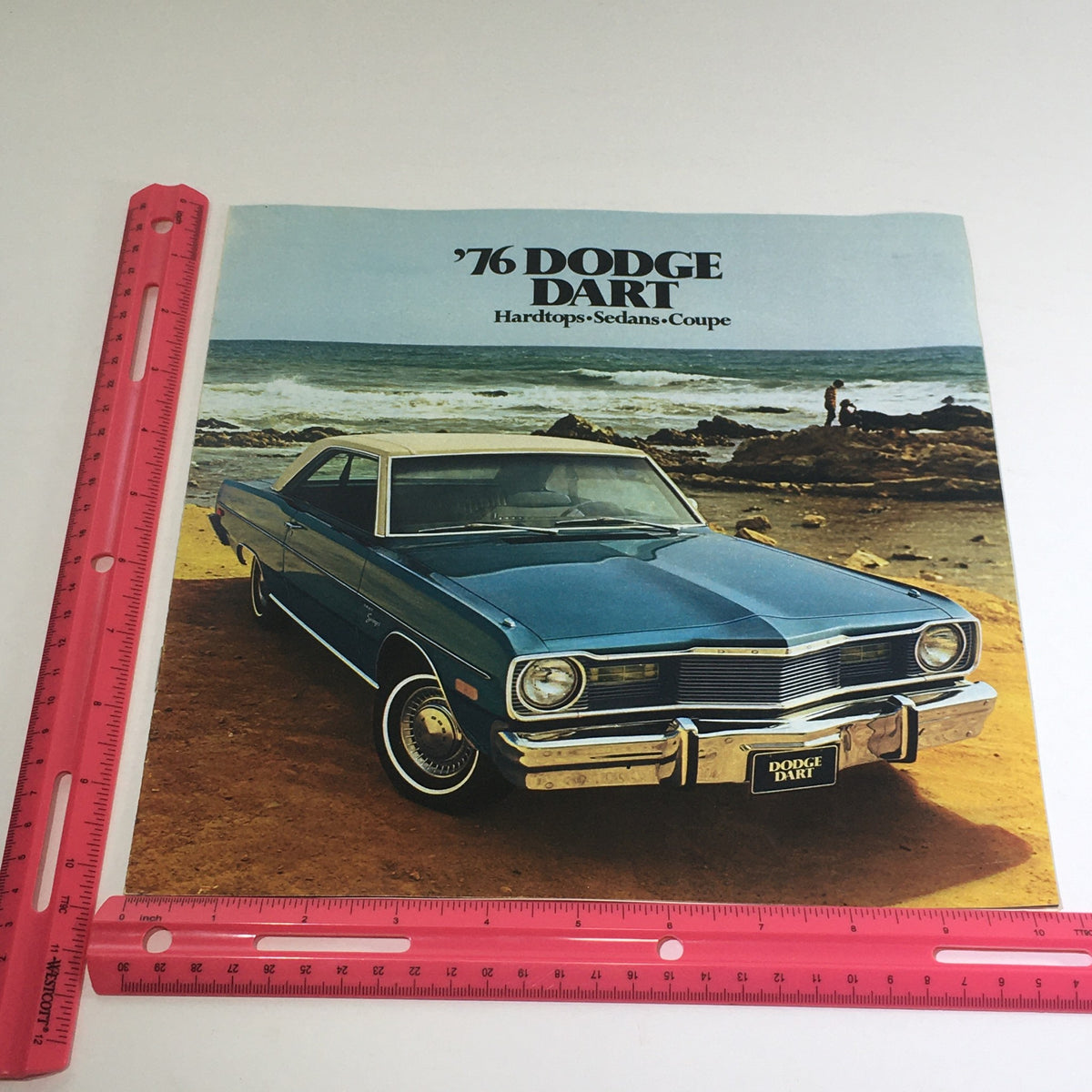 1976 Dodge Dart Hardtops, Sedans, Coupe Specifications Car Auto Brochure Catalog cover featuring a blue Dodge Dart parked on a beach with text highlighting the models available.