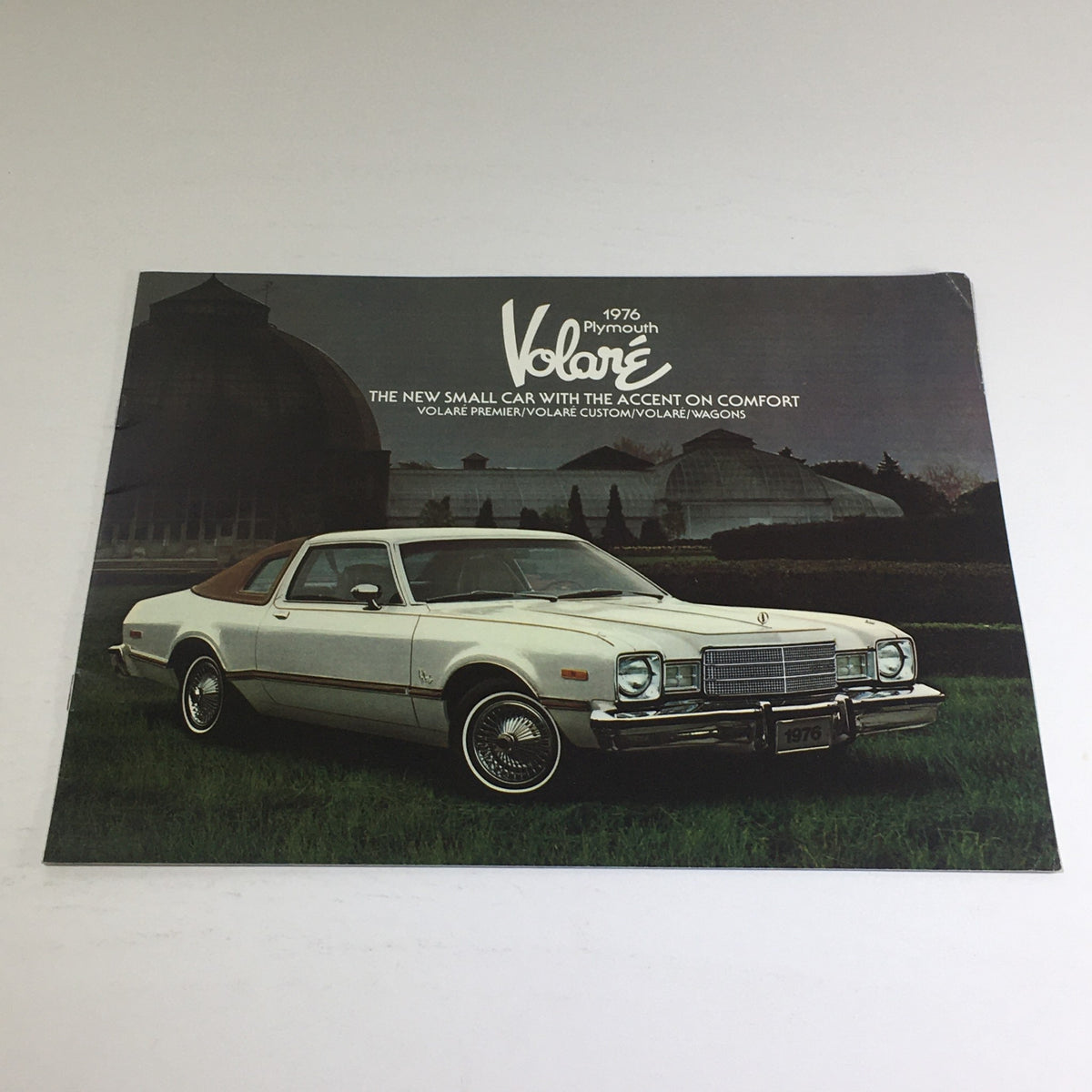 1976 Plymouth Volare Premier, Custom, Wagons Features Car Auto Brochure Catalog showcasing the car with a backdrop of greenery, highlighting its stylish design and features.