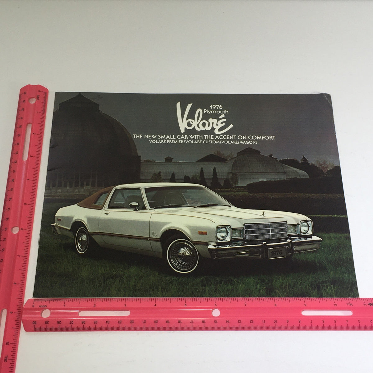 The front cover of the 1976 Plymouth Volare brochure highlighting the Volare model, featuring a stylish brown and white custom car on a scenic background.