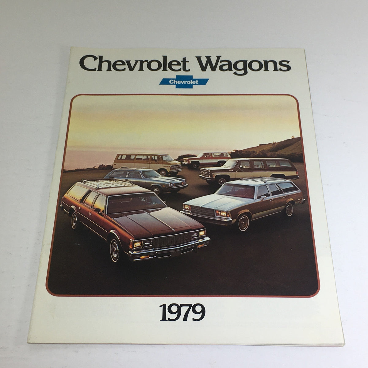 Cover of the 1979 Chevrolet Caprice & Impala Wagons Specifications Car Auto Brochure Catalog featuring classic Chevy wagons in a scenic setting.