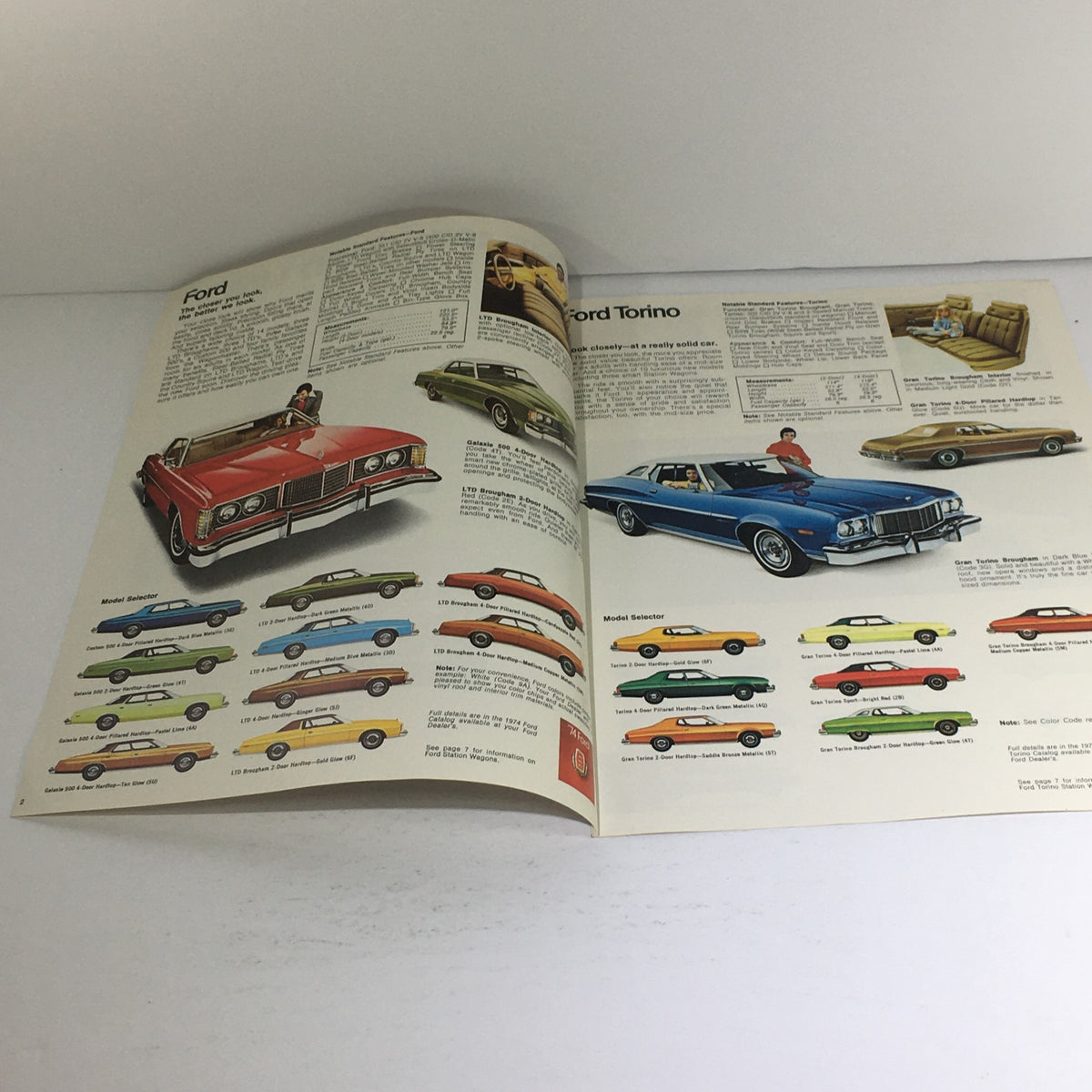 Open page of the 1974 Ford Torno/Mustang II/Maverick Dealership Car Auto Brochure Catalog showcasing Ford Torino cars with detailed information and color options.