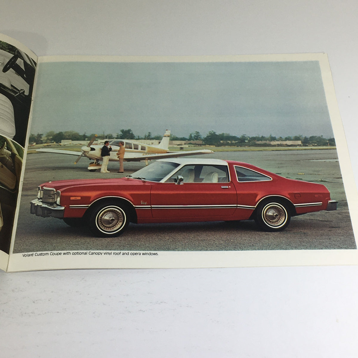 1977 Plymouth Volare Custom Two-Tone Coupe dealership brochure featuring a red car with optional canopy vinyl roof, parked by an airport.