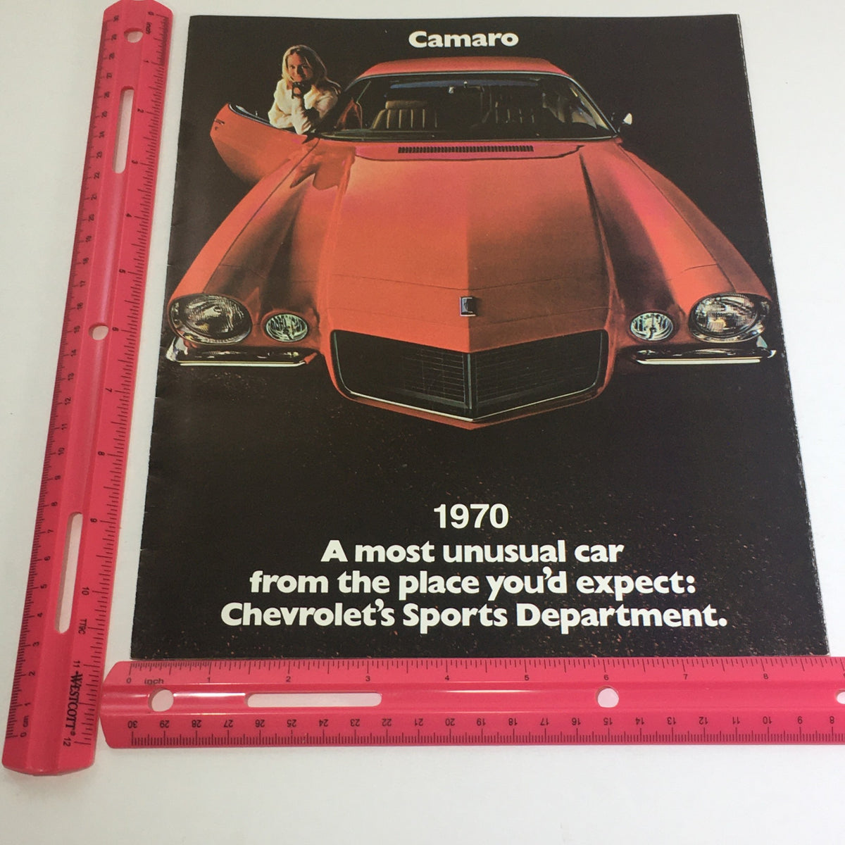 1970 Chevrolet Camaro Sport Coupe Z-25 Dealership Car Auto Brochure Catalog highlighting a vibrant red Camaro with a woman beside it, emphasizing its unique design.
