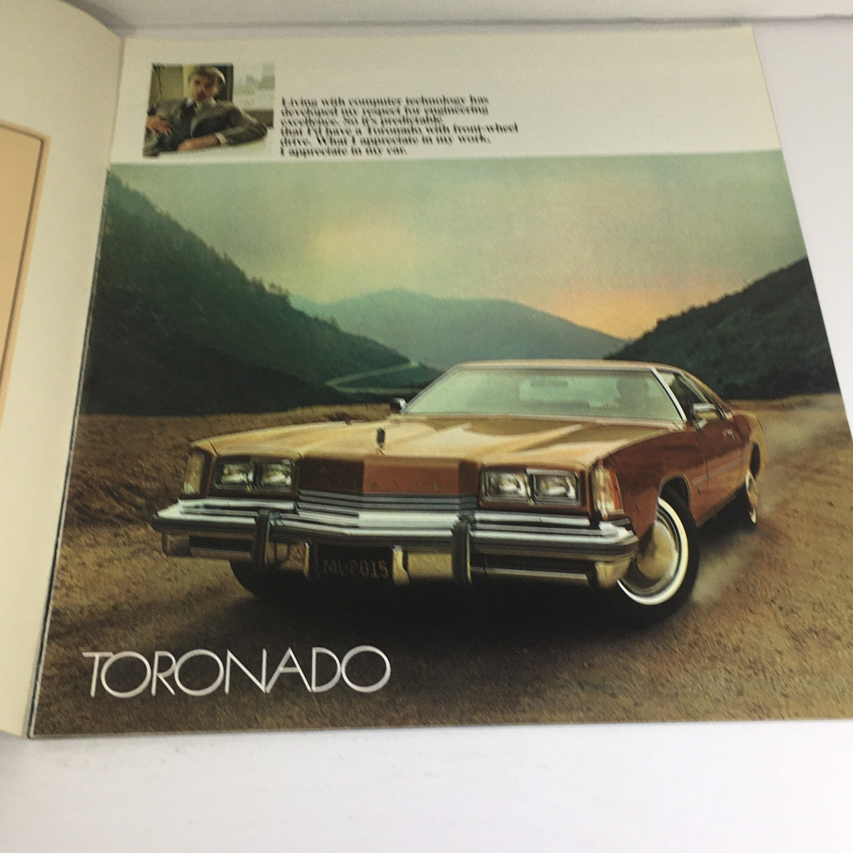 Detailed interior page of the 1976 Oldsmobile Toronado brochure featuring a brown car on a scenic mountain road.