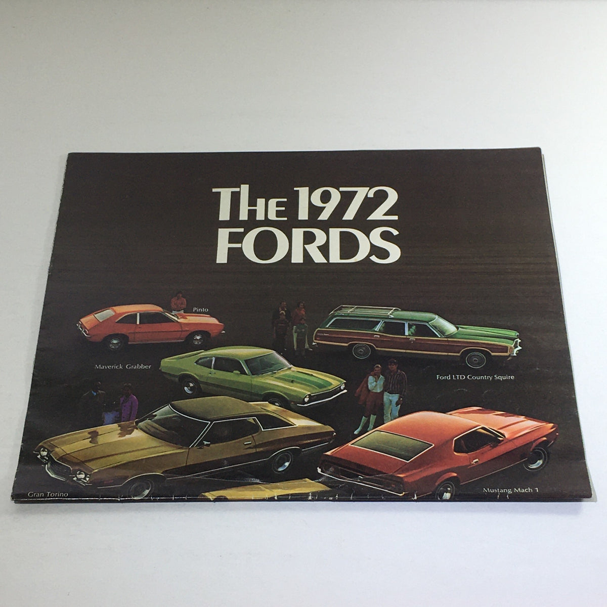 Front cover of the 1972 Fords LTD Brougham & ft. 39 Models Dealership Car Auto Brochure Catalog featuring a lineup of classic Ford cars including Pinto, Maverick Grabber, and Ford LTD Country Squire.