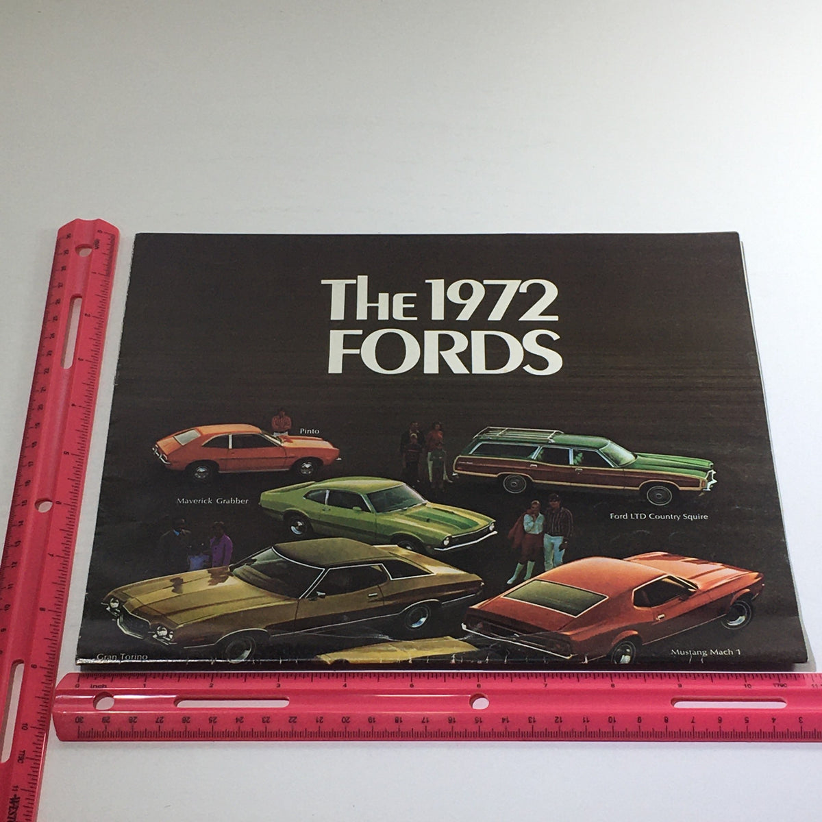 1972 Fords brochure cover featuring an array of Ford vehicles including Pinto, Maverick Grabber, Ford LTD Country Squire, and Mustang Mach 1.