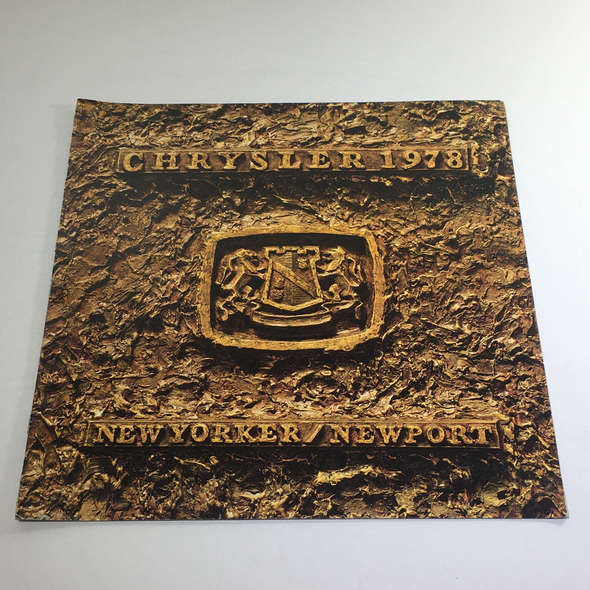 Cover of the 1978 Chrysler New Yorker/New Port Features dealership auto brochure catalog showcasing a textured design with the Chrysler emblem.